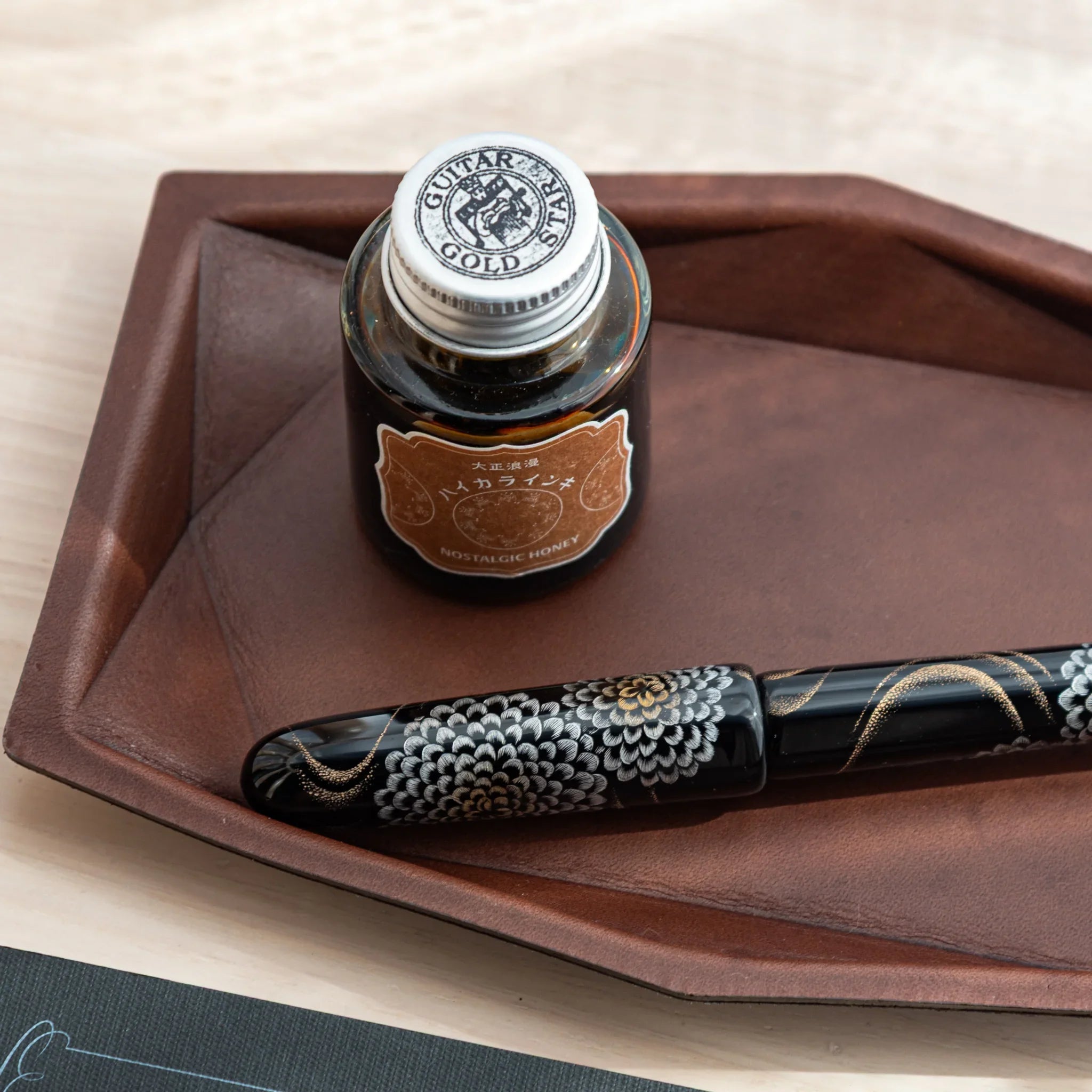 Hexagonal brown Japanese Pen Tray made of leather, photographed from top view.