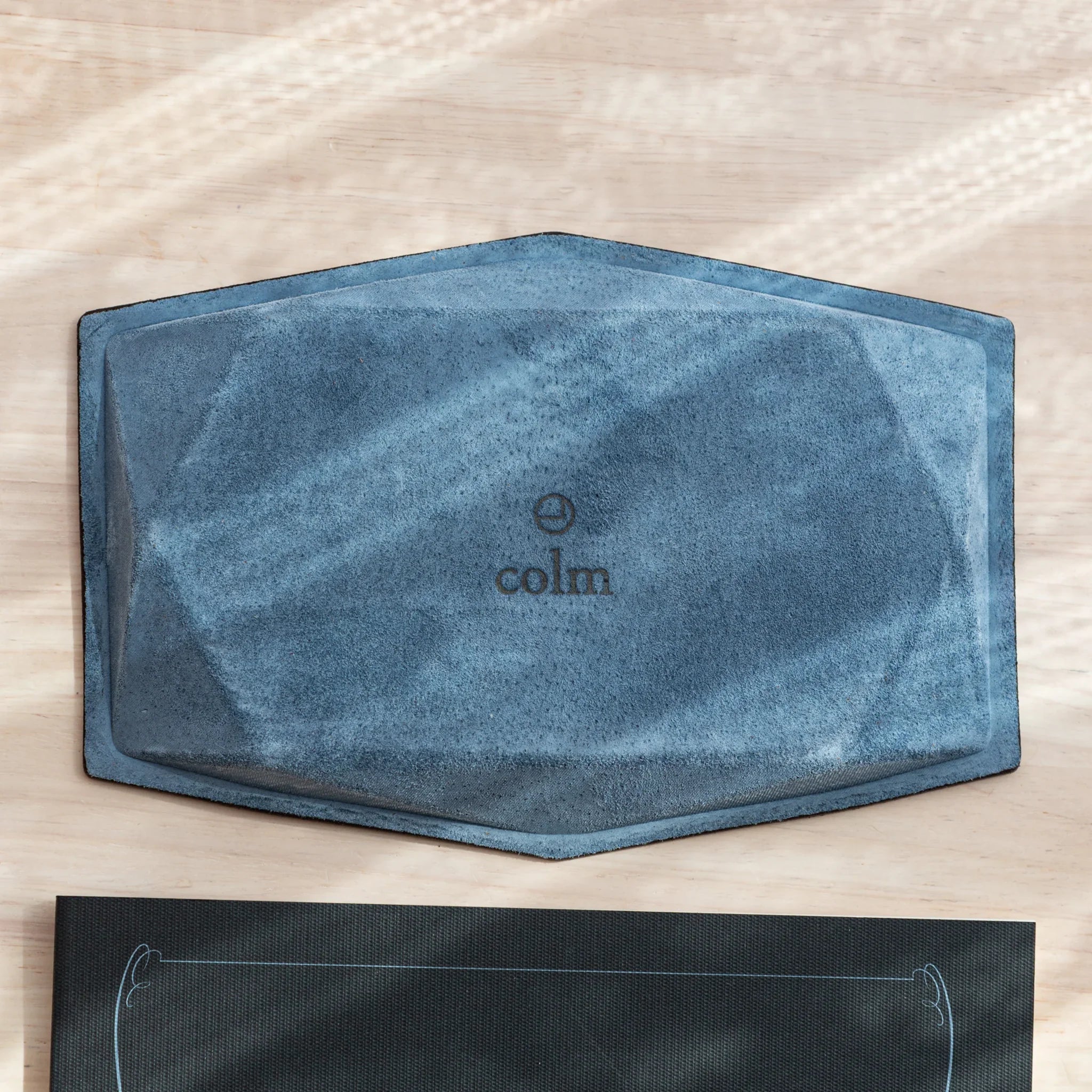 Bottom view of the blue suede Japanese Pen Tray with the colm logo in the center.