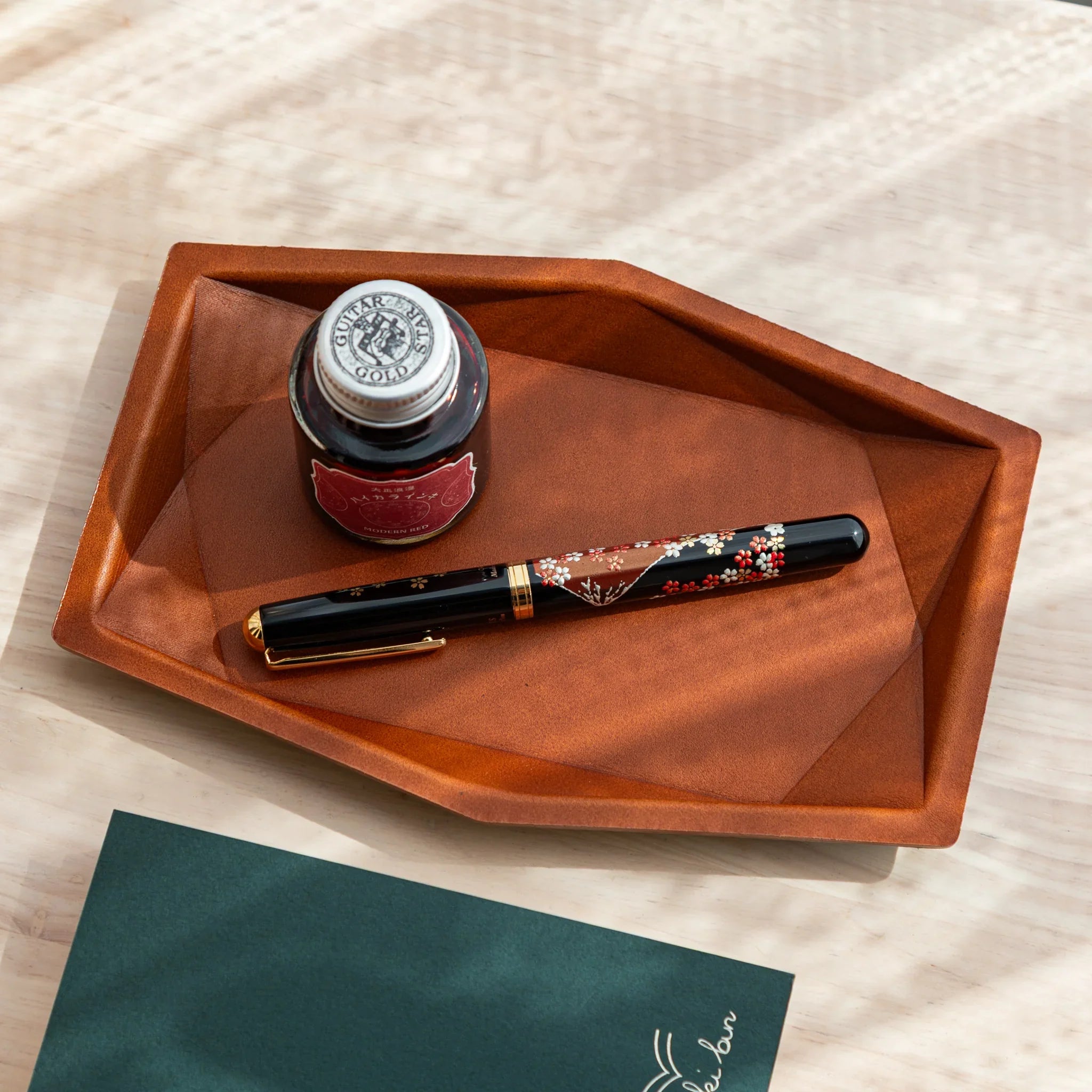 Camel Japanese Pen Tray holding a Japanese fountain pen and red ink bottle.
