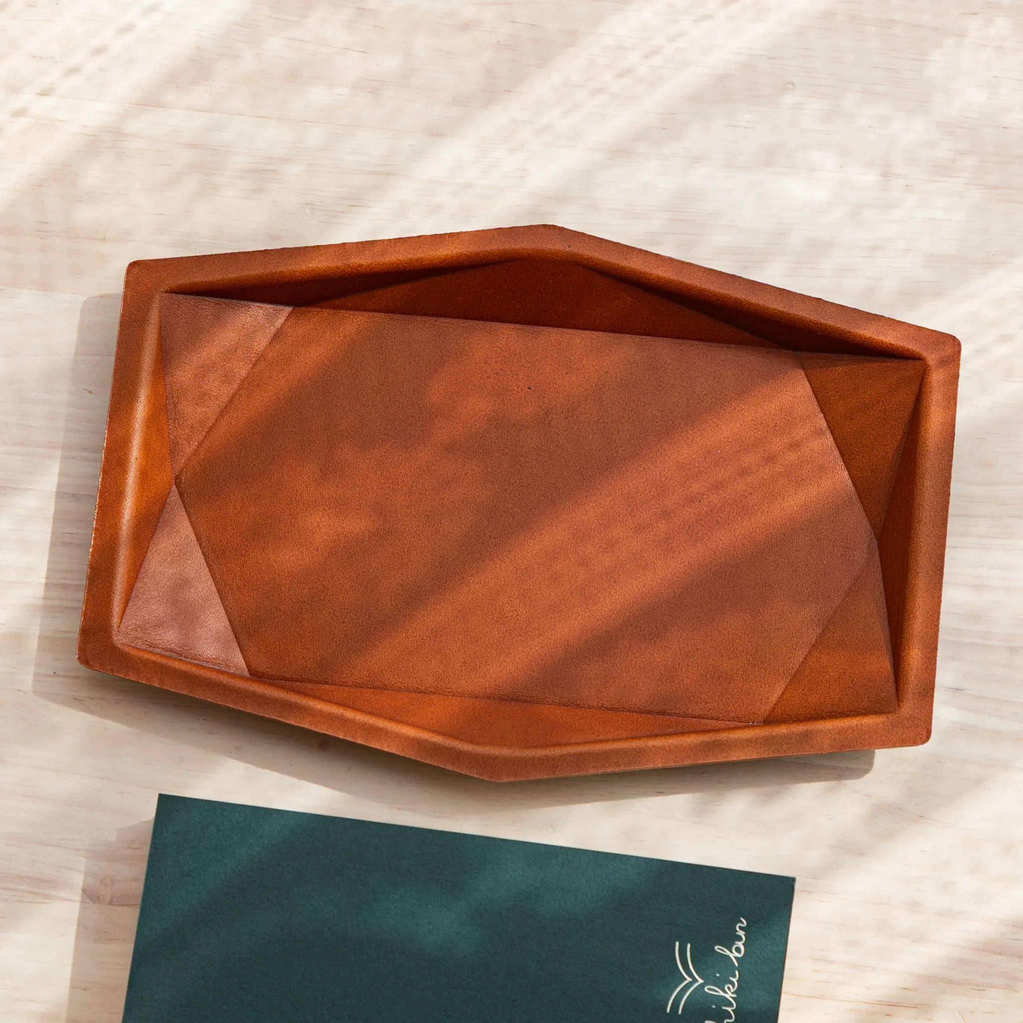 Top view of the camel leather Japanese Pen Tray placed on a wooden desk.