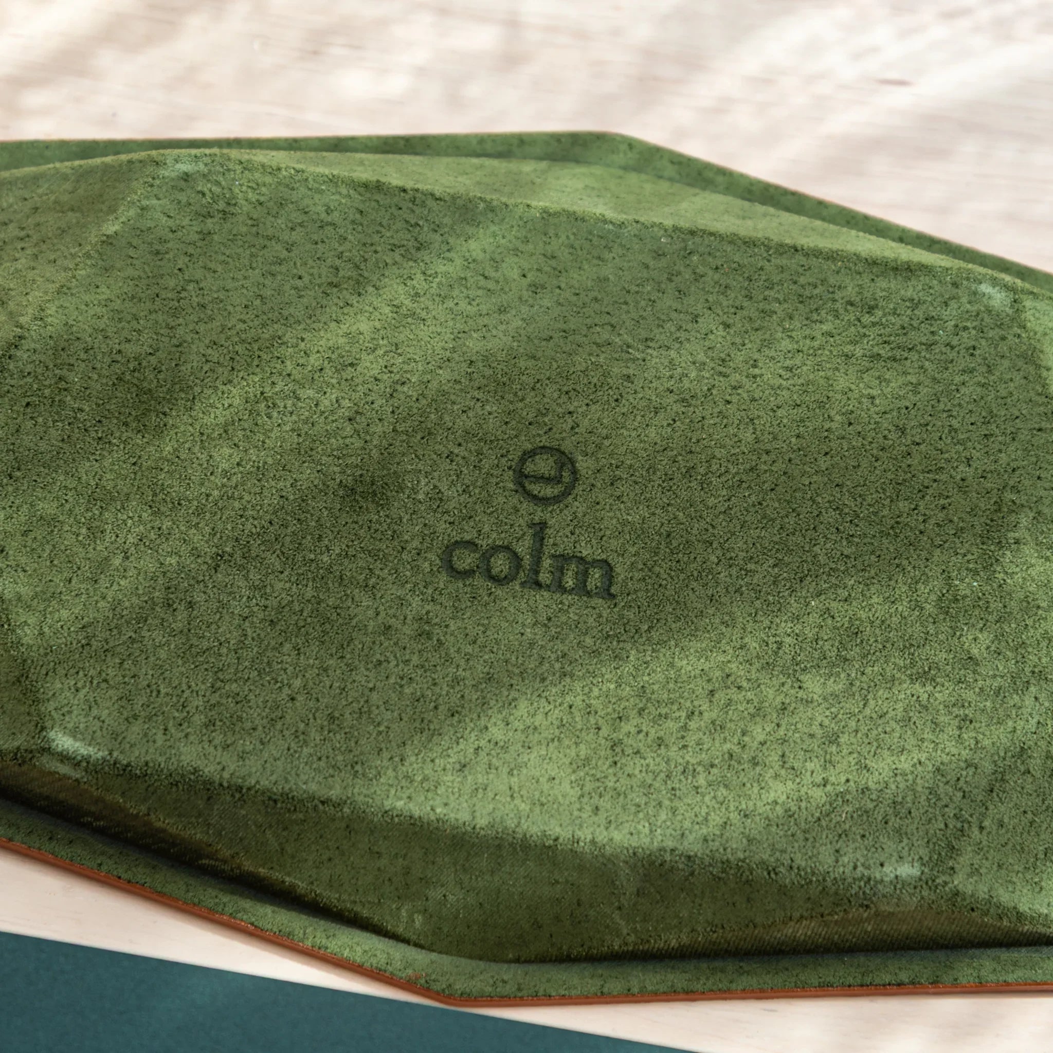 Close-up of colm branding on the suede underside of the Tatsuno Leather Pen Tray Slim.