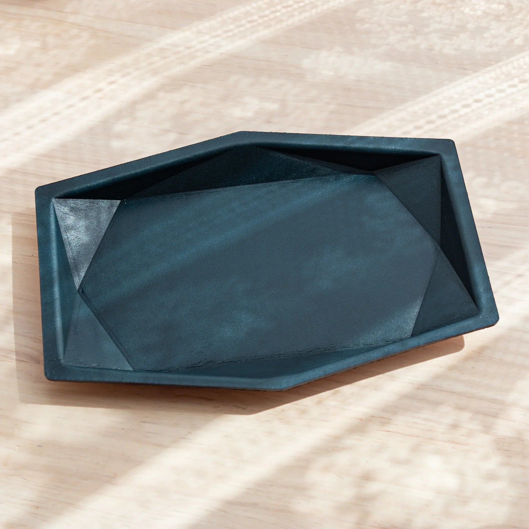 Top view of Japanese Pen Tray in Teal-Blue leather with a clean, geometric hexagonal shape.