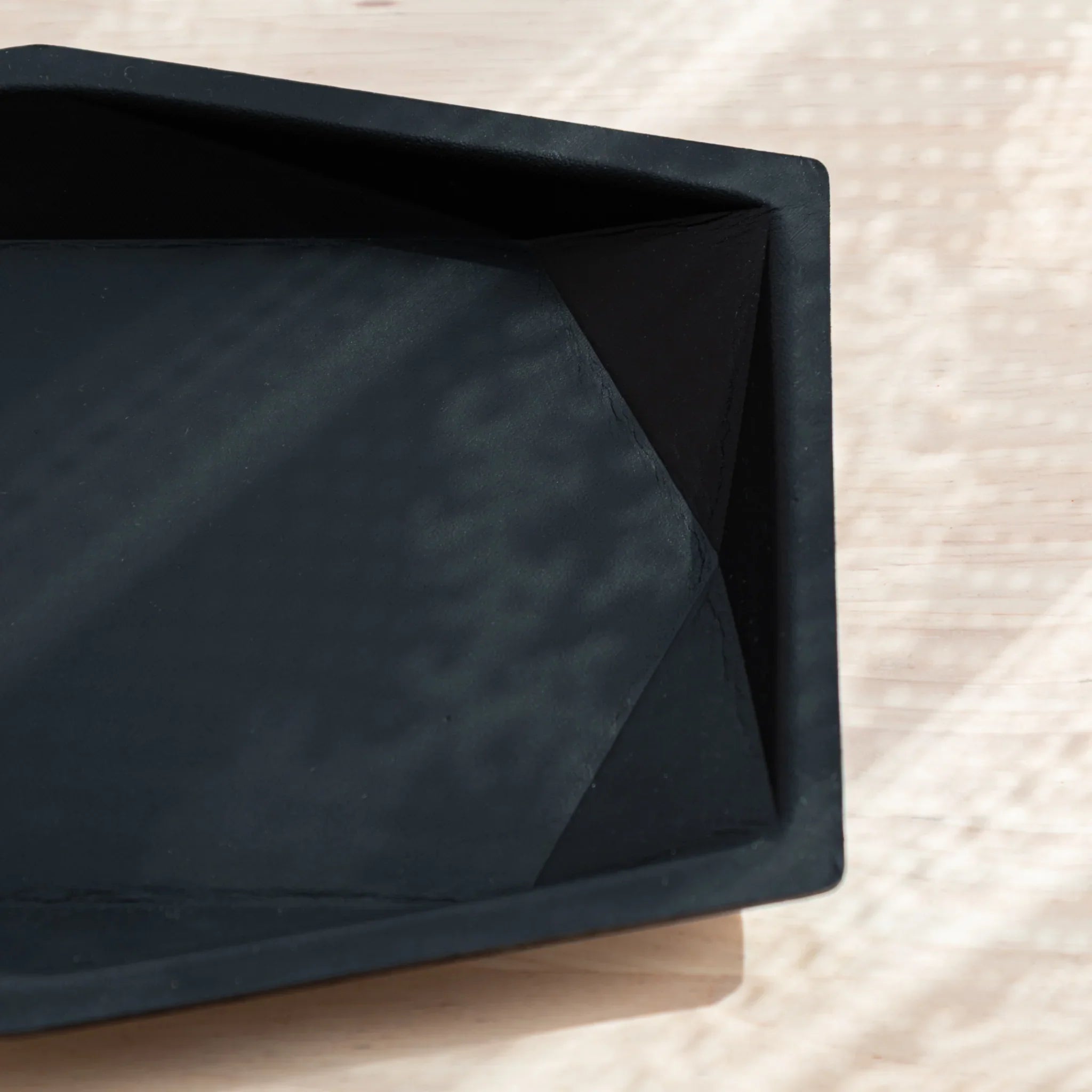 Close-up of the right corner of a black Japanese Pen Tray made from leather.