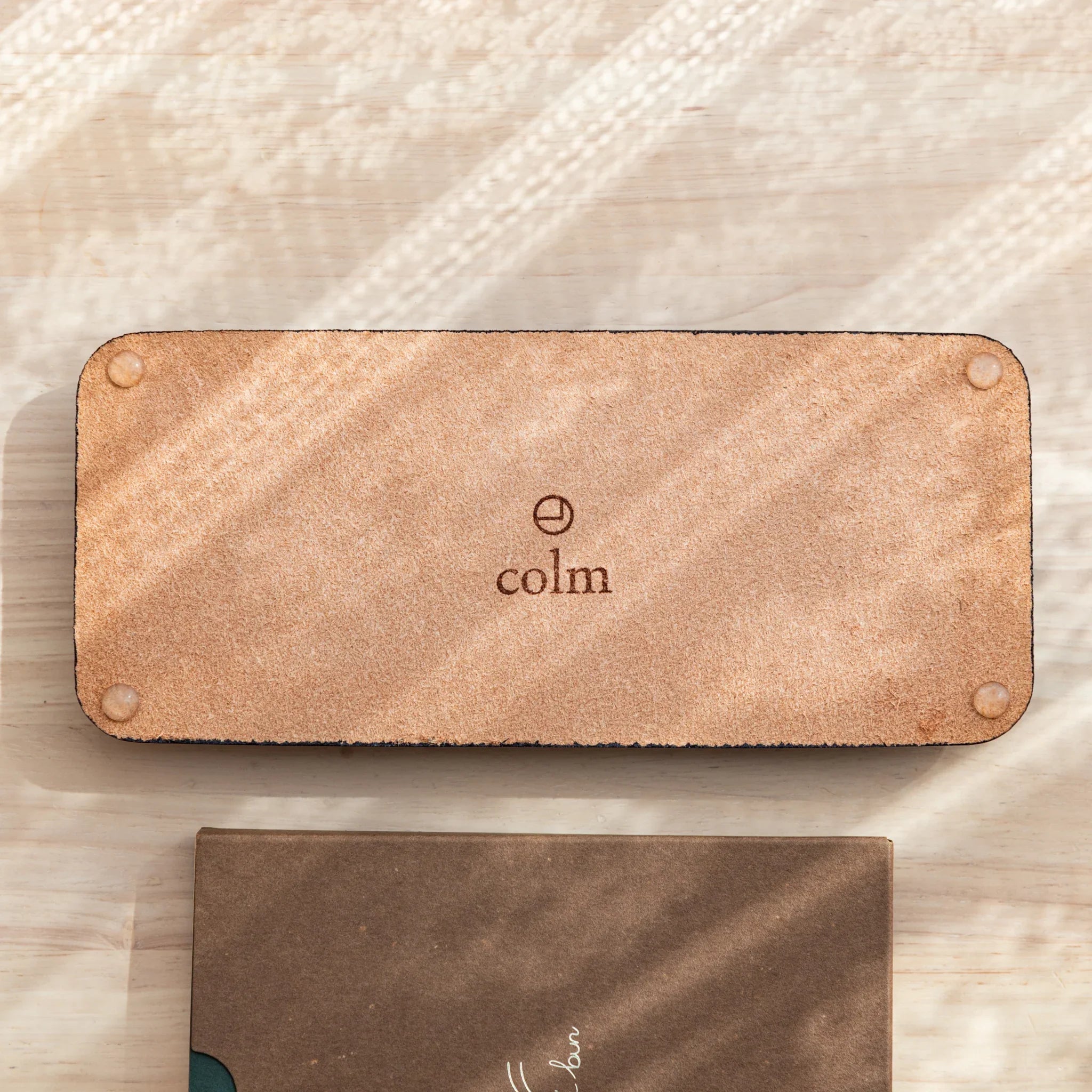 Suede back of Tatsuno Leather Pen Tray Slim with colm logo and rubber pads.