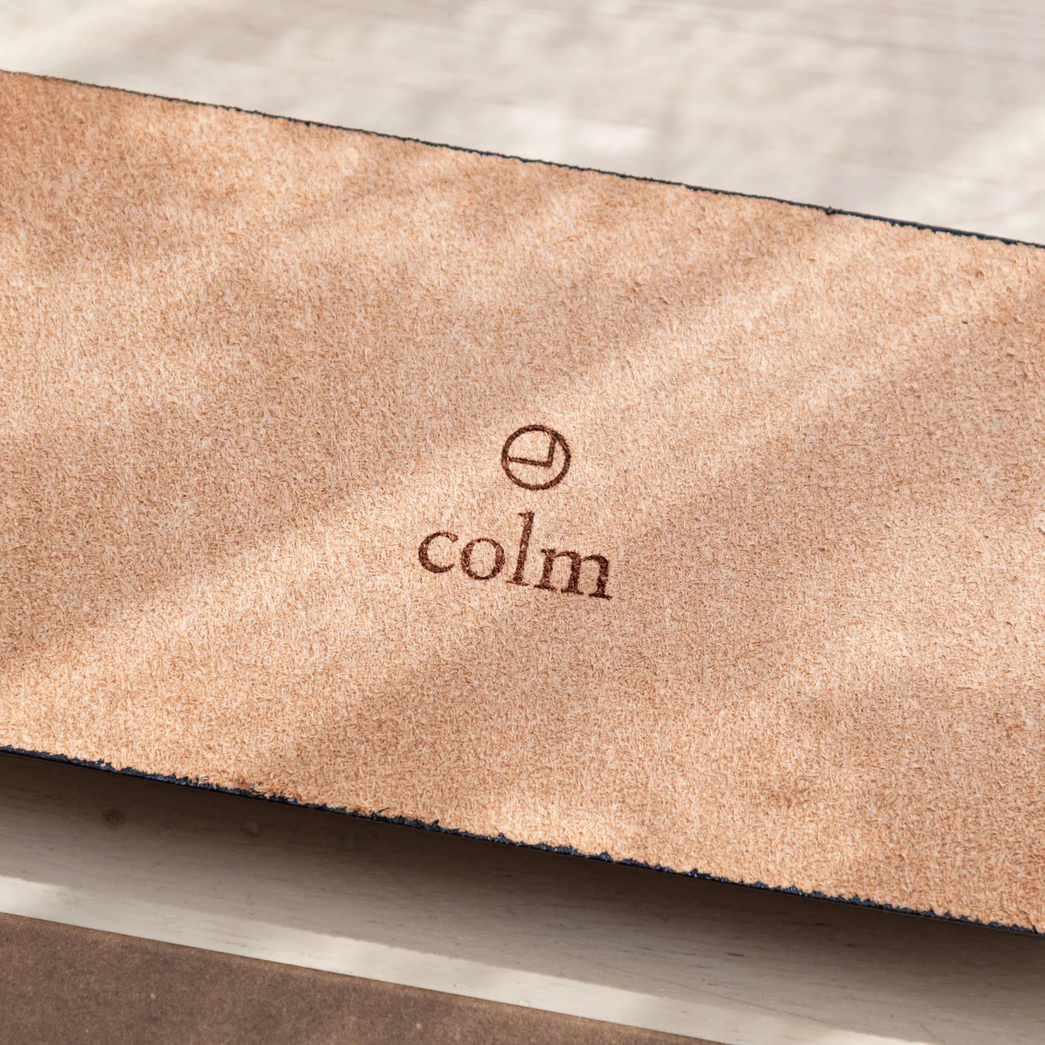 Close-up of colm logo embossed on suede back of the Japanese Pen Tray.