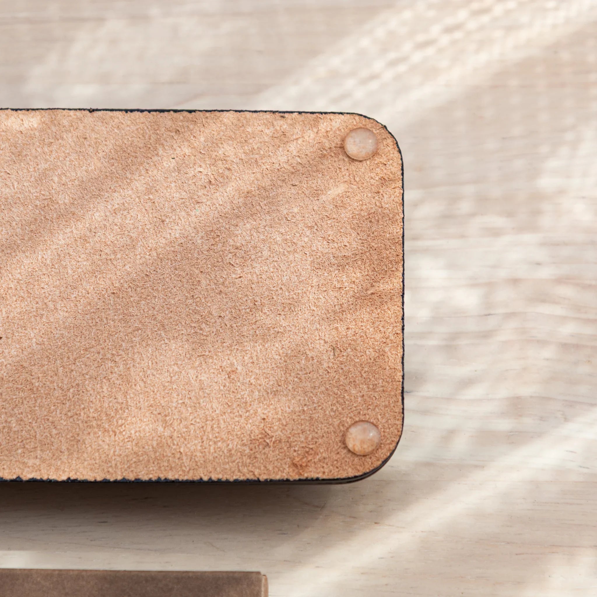 Detail of anti-slip rubber pads on bottom of Tatsuno Leather Pen Tray Slim.
