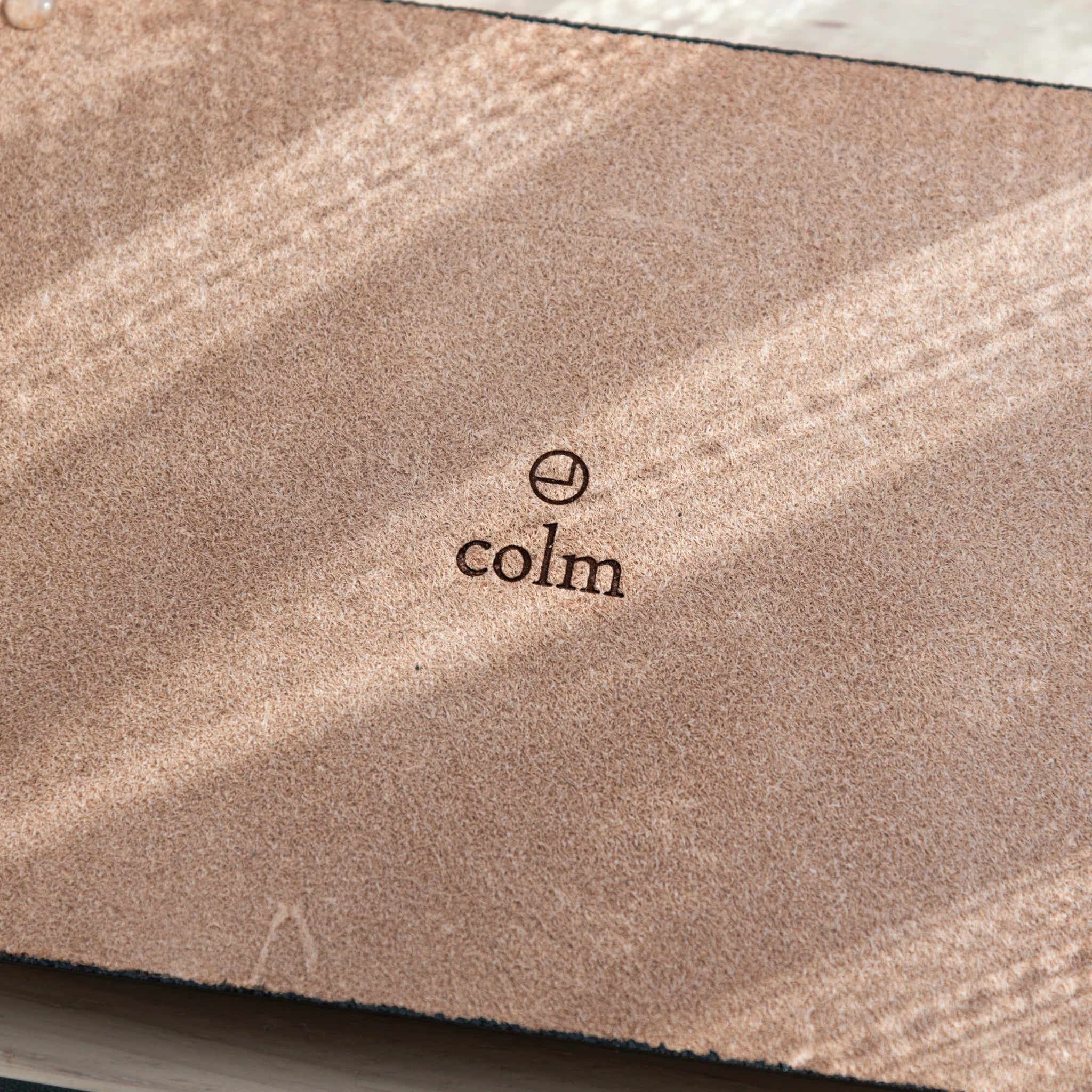 Suede back of Tatsuno Leather Pen Tray Wide with colm logo and rubber pads.