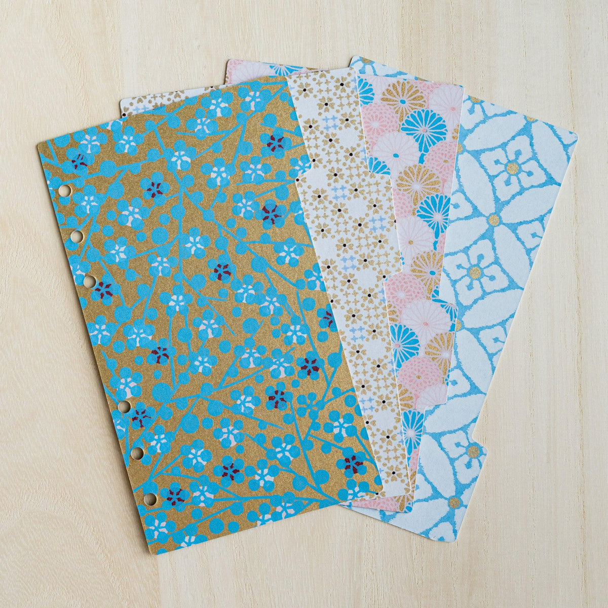 Four Tone Yuzen washi index dividers for Bible size planners fanned out, gold, pink and blue floral prints