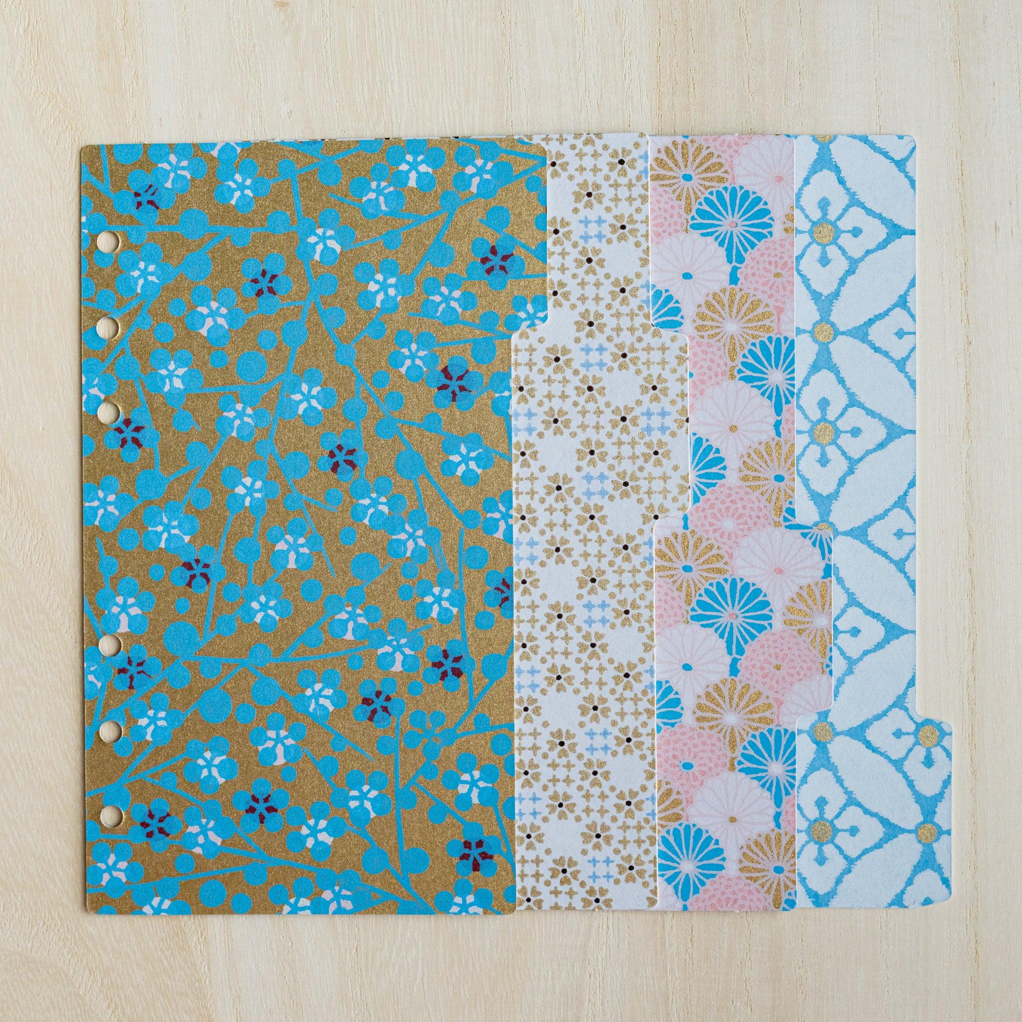 Four Tone Yuzen washi index dividers overlapped in a row, showing stepped side tabs and gold floral prints