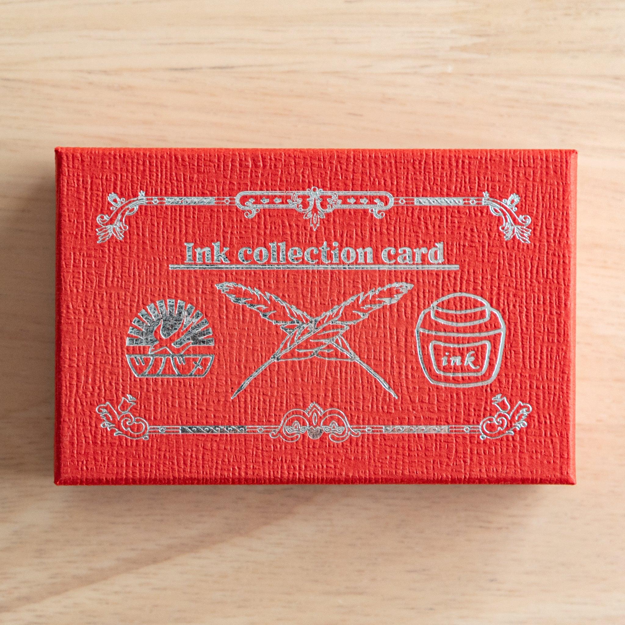 A close-up of a red Tsubame Japanese stationery box with silver embossed details, labeled "Ink collection card," designed for organizing fountain pen ink swatches.  