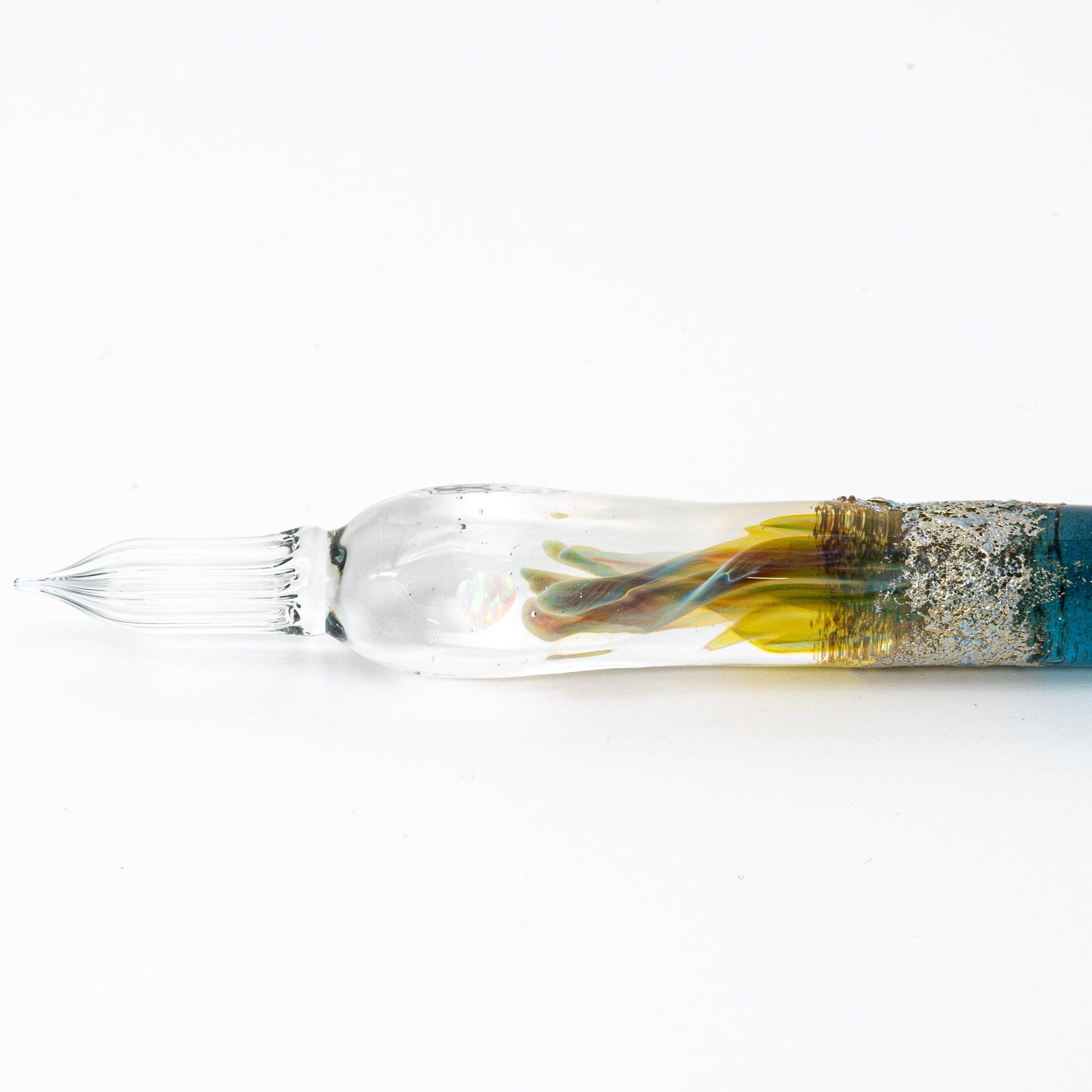 Elegant glass pen with a suspended opal and silver accents, featuring a gradient from blue to clear. Perfect for luxury writing experiences.