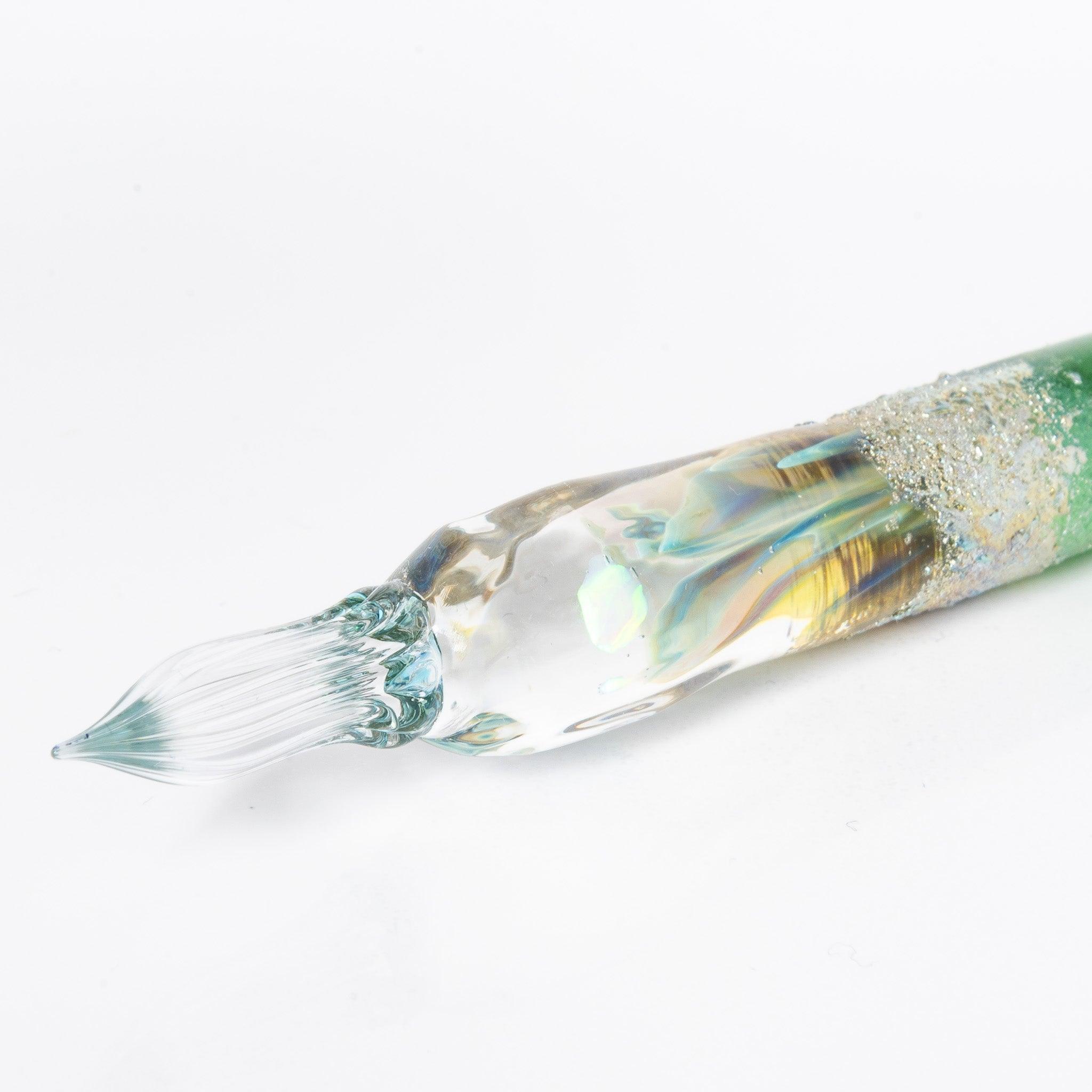 Glass pen with a light blue gradient and suspended opal, accented with silver. A luxurious writing instrument for those who appreciate elegance.