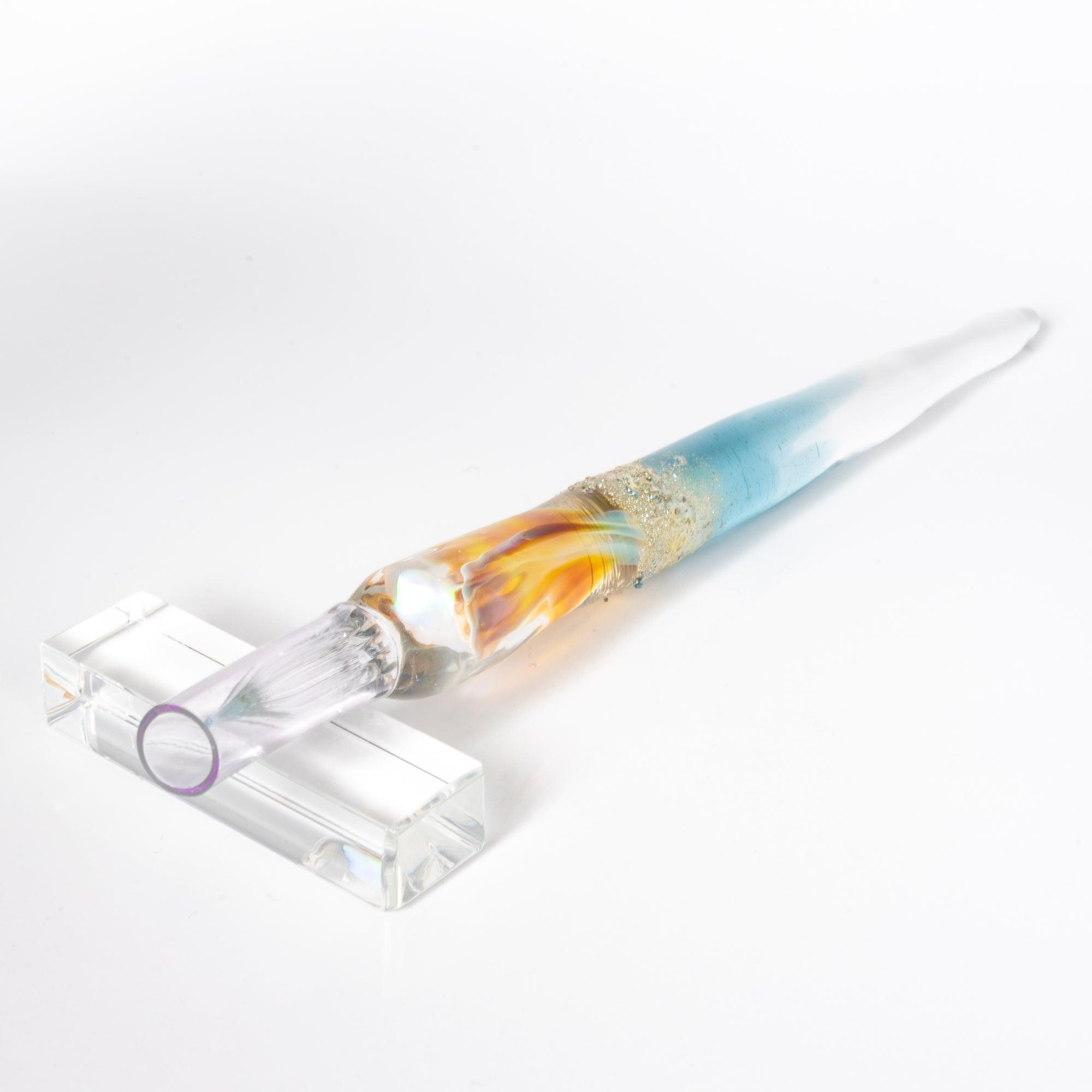 Glass pen with a light blue gradient and suspended opal, accented with silver. A luxurious writing instrument for those who appreciate elegance.