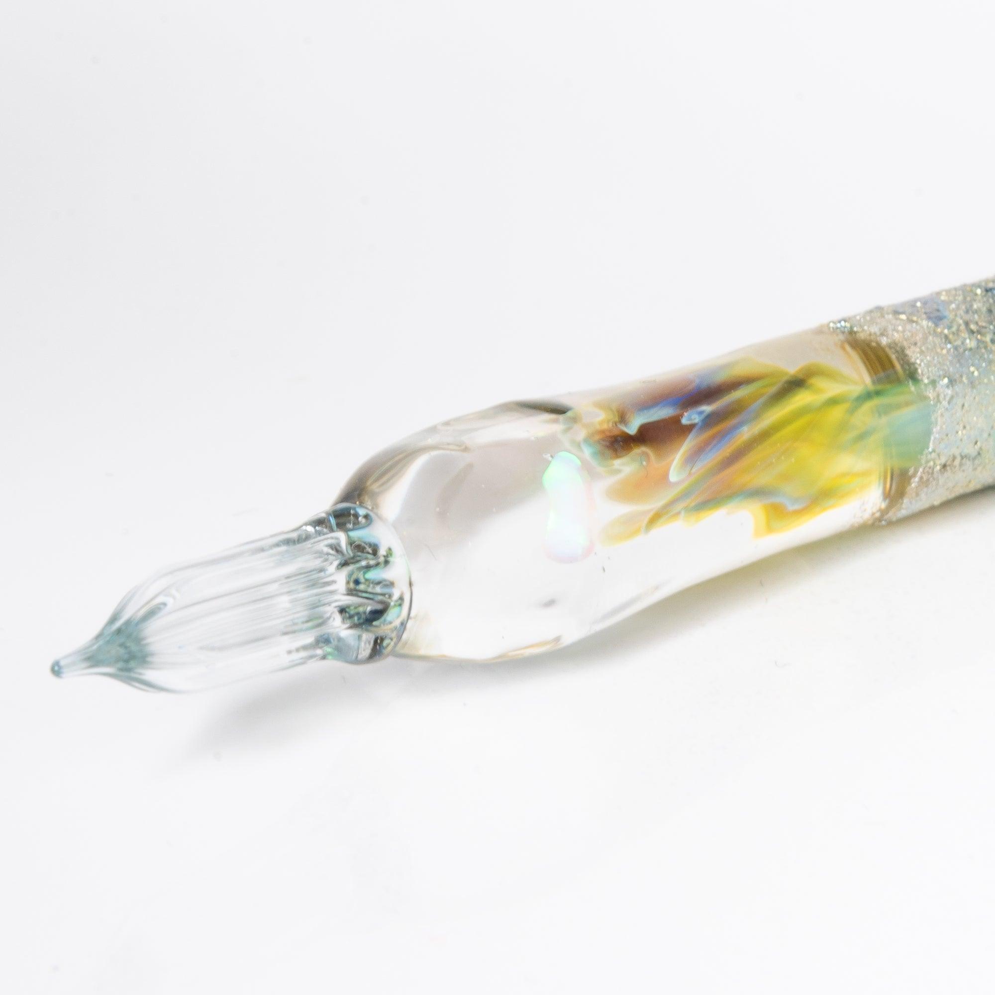 Glass pen with a light blue gradient and suspended opal, accented with silver. A luxurious writing instrument for those who appreciate elegance.