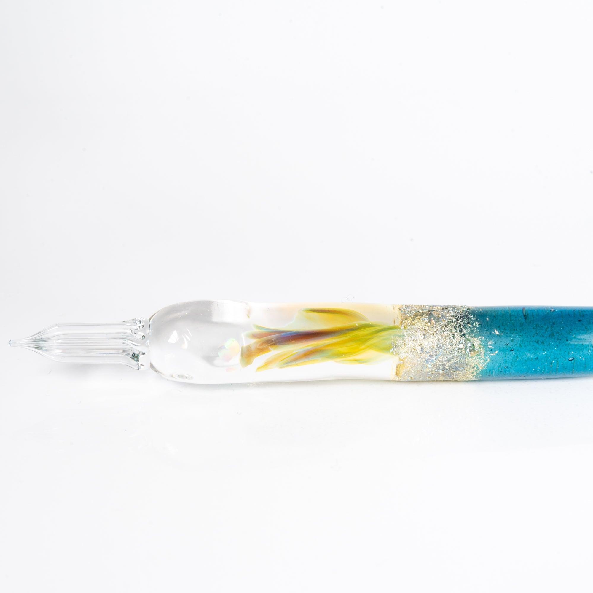 Glass pen with a light blue gradient and suspended opal, accented with silver. A luxurious writing instrument for those who appreciate elegance.