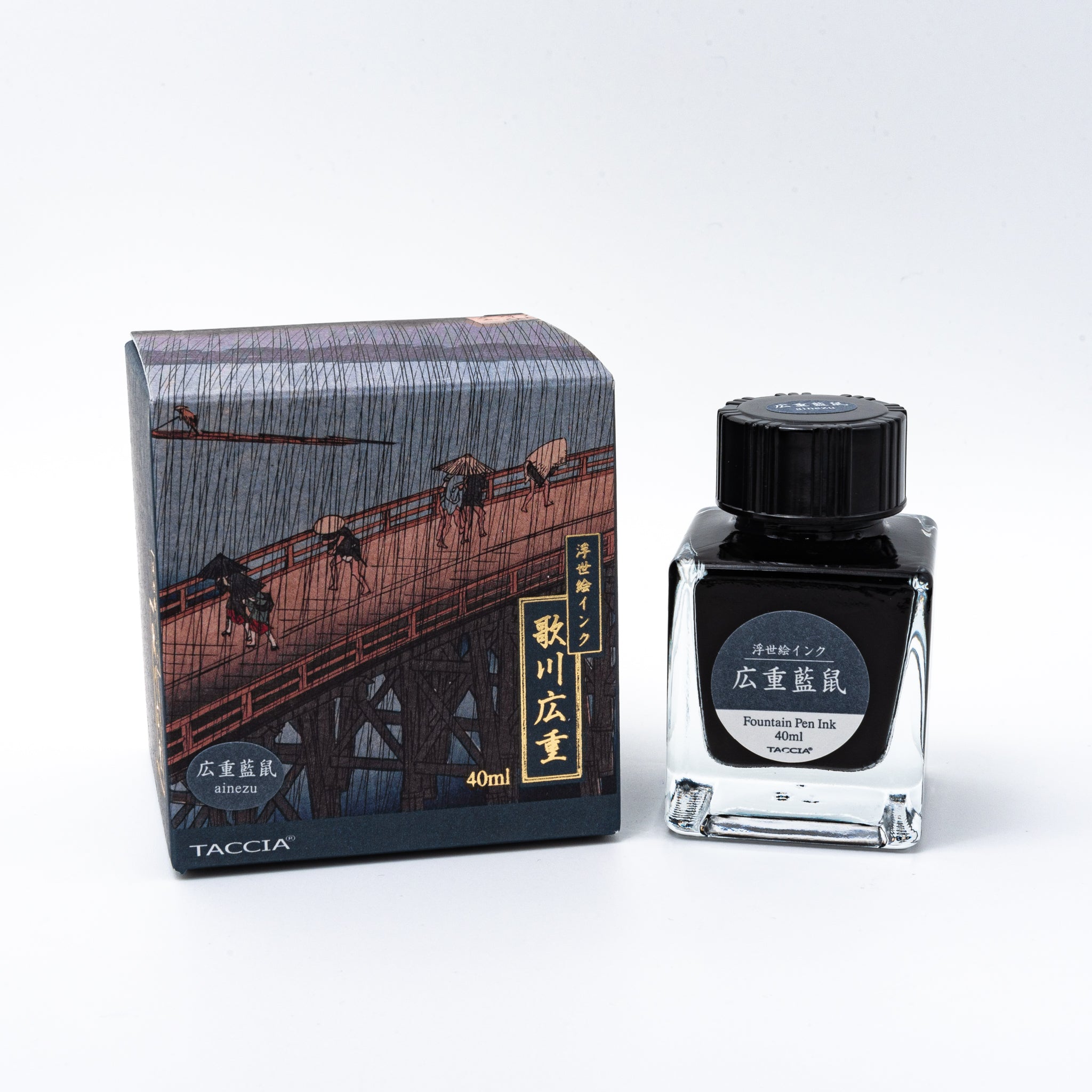 Japanese stationery fountain pen ink. The packaging features Ukiyo-e style art of a rainy bridge scene. The glass bottle contains 40ml of blue-gray "Ainezu" ink.  