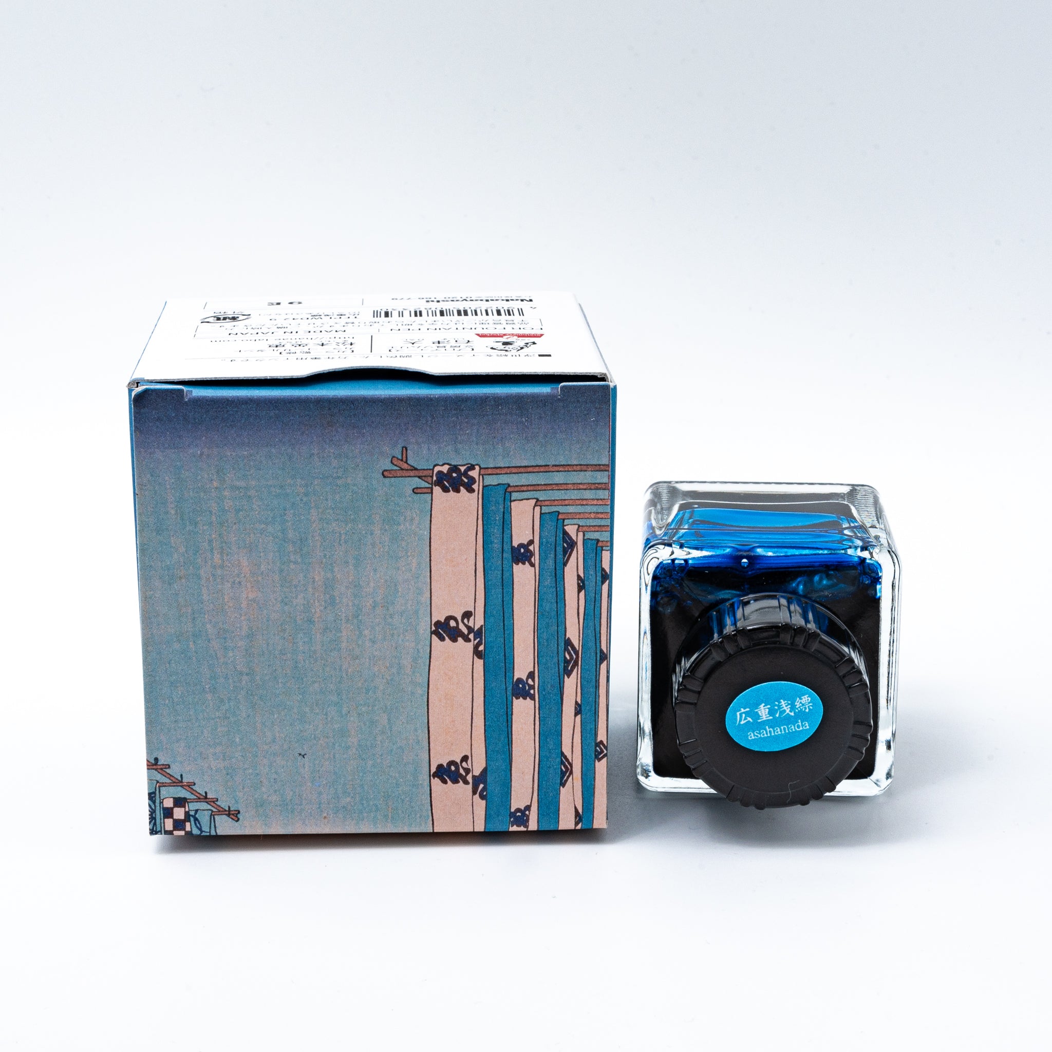 Japanese stationery fountain pen ink. The packaging features Ukiyo-e style art of Mount Fuji with blue curtains in the foreground. The glass bottle contains 40ml of light blue "Asahanada" ink.  