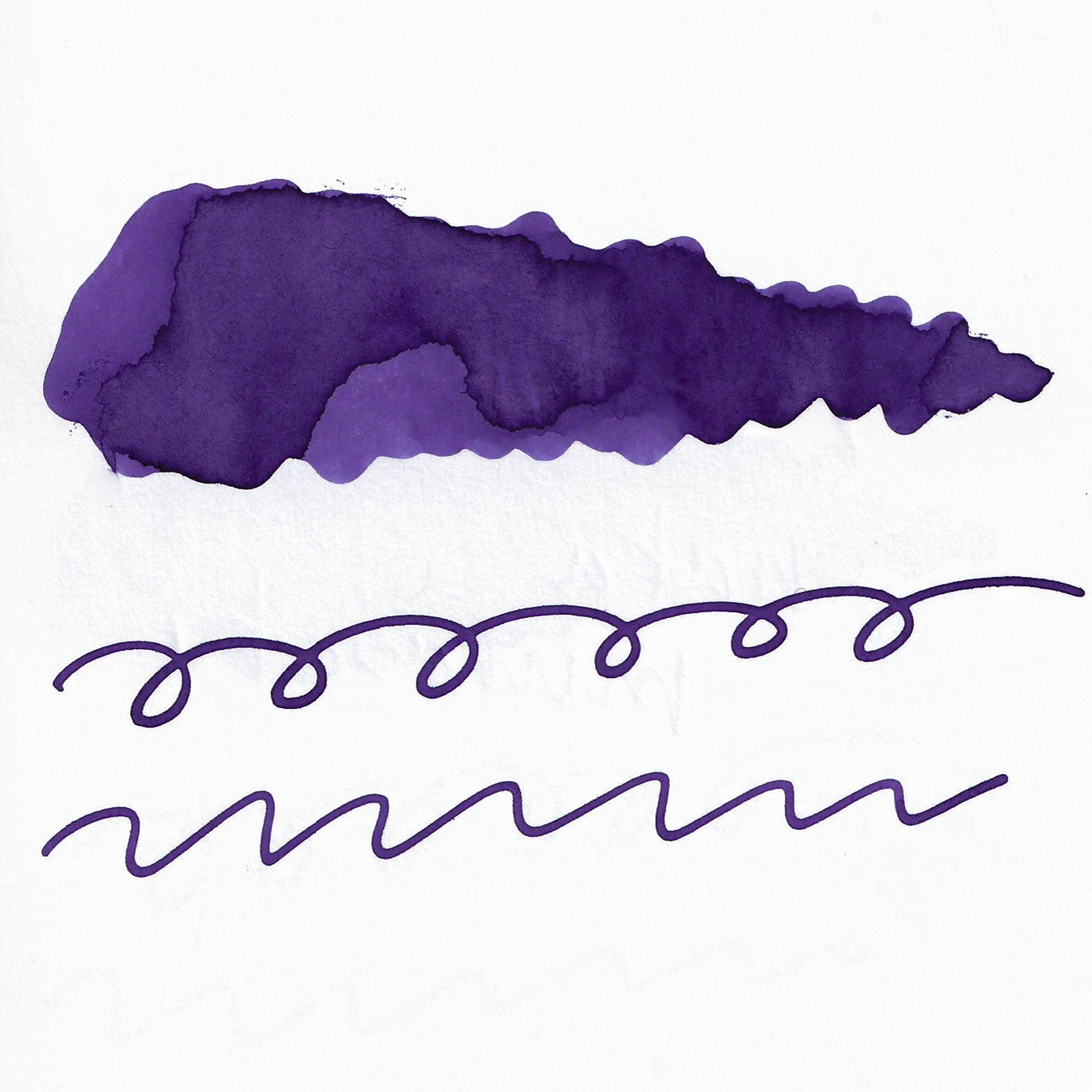 Swatch of purple fountain pen ink on white paper. The ink shows shading variations, with a dark center and lighter edges. Below are wavy and looped lines demonstrating the ink's flow.  