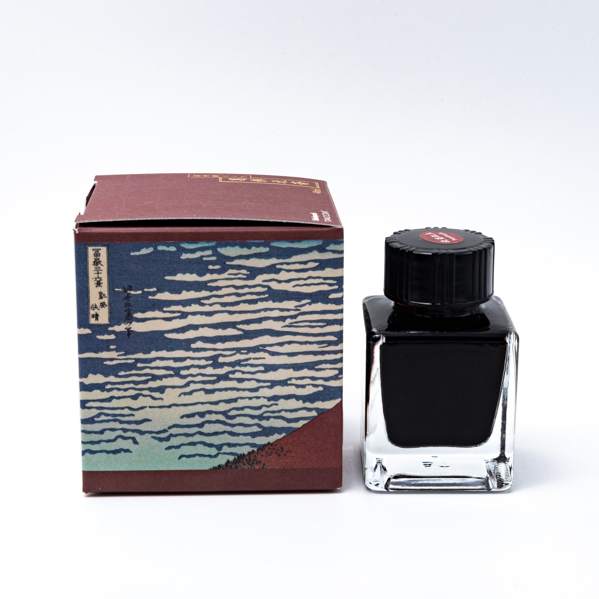 Japanese stationery fountain pen ink. The packaging features Ukiyo-e style art of Mount Fuji with a reddish-brown sky. The glass bottle contains 40ml of red "Benitsuchi" ink.  