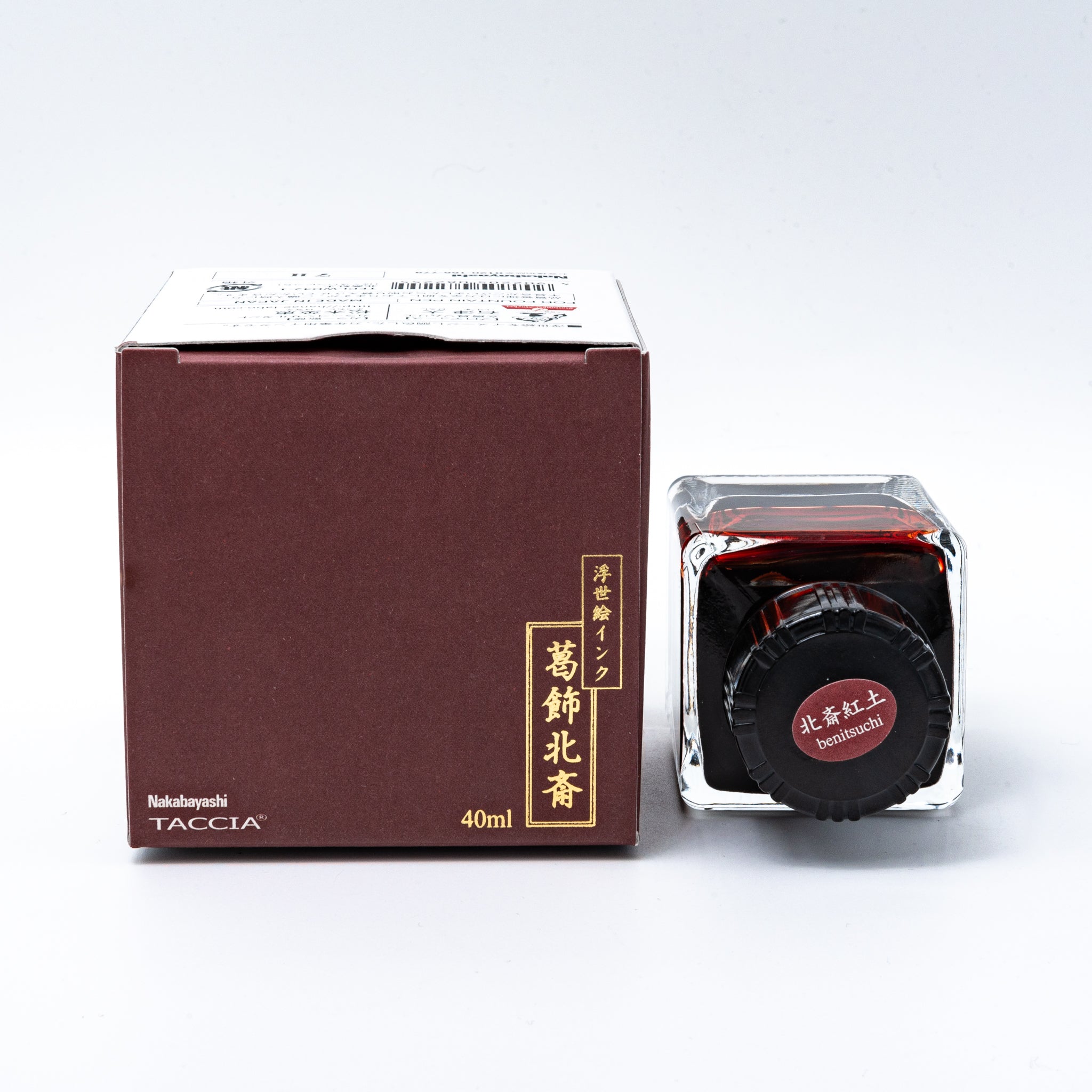 Japanese stationery fountain pen ink. The packaging features Ukiyo-e style art of Mount Fuji with a reddish-brown sky. The glass bottle contains 40ml of red "Benitsuchi" ink.  