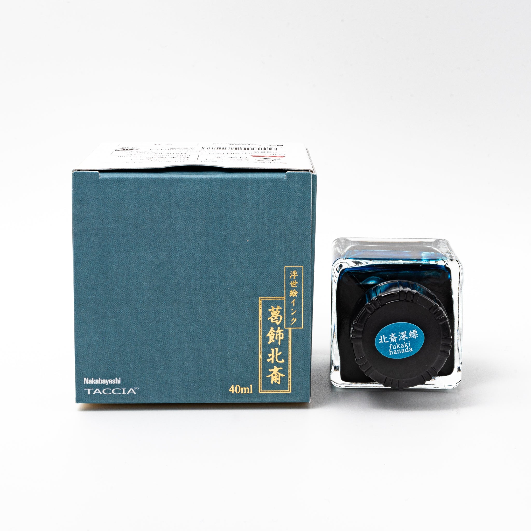 Japanese stationery fountain pen ink. The packaging features Ukiyo-e style art of Mount Fuji with fishermen pulling nets. The glass bottle contains 40ml of deep blue "Fukaki Hanada" ink.  