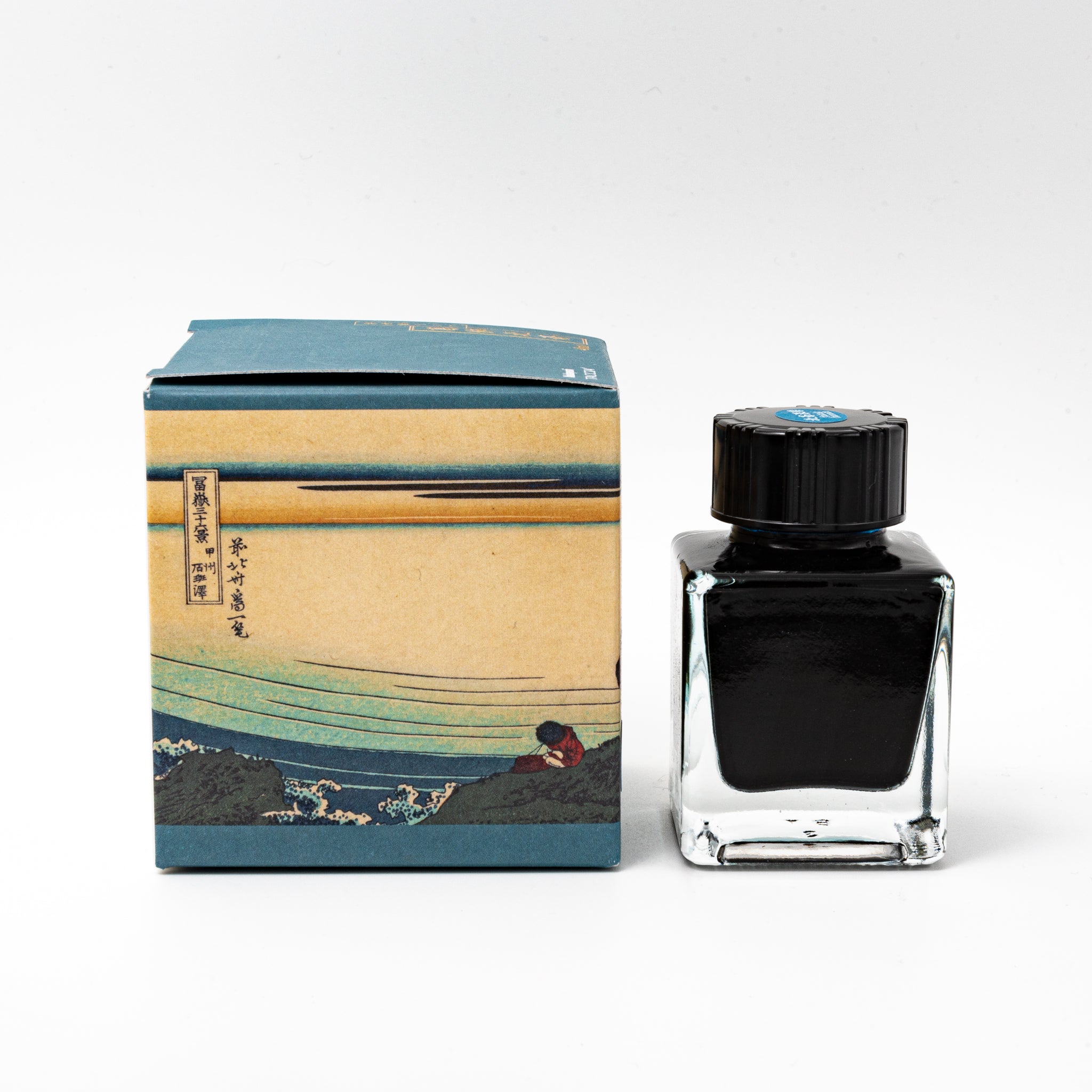 Japanese stationery fountain pen ink. The packaging features Ukiyo-e style art of Mount Fuji with fishermen pulling nets. The glass bottle contains 40ml of deep blue "Fukaki Hanada" ink.  