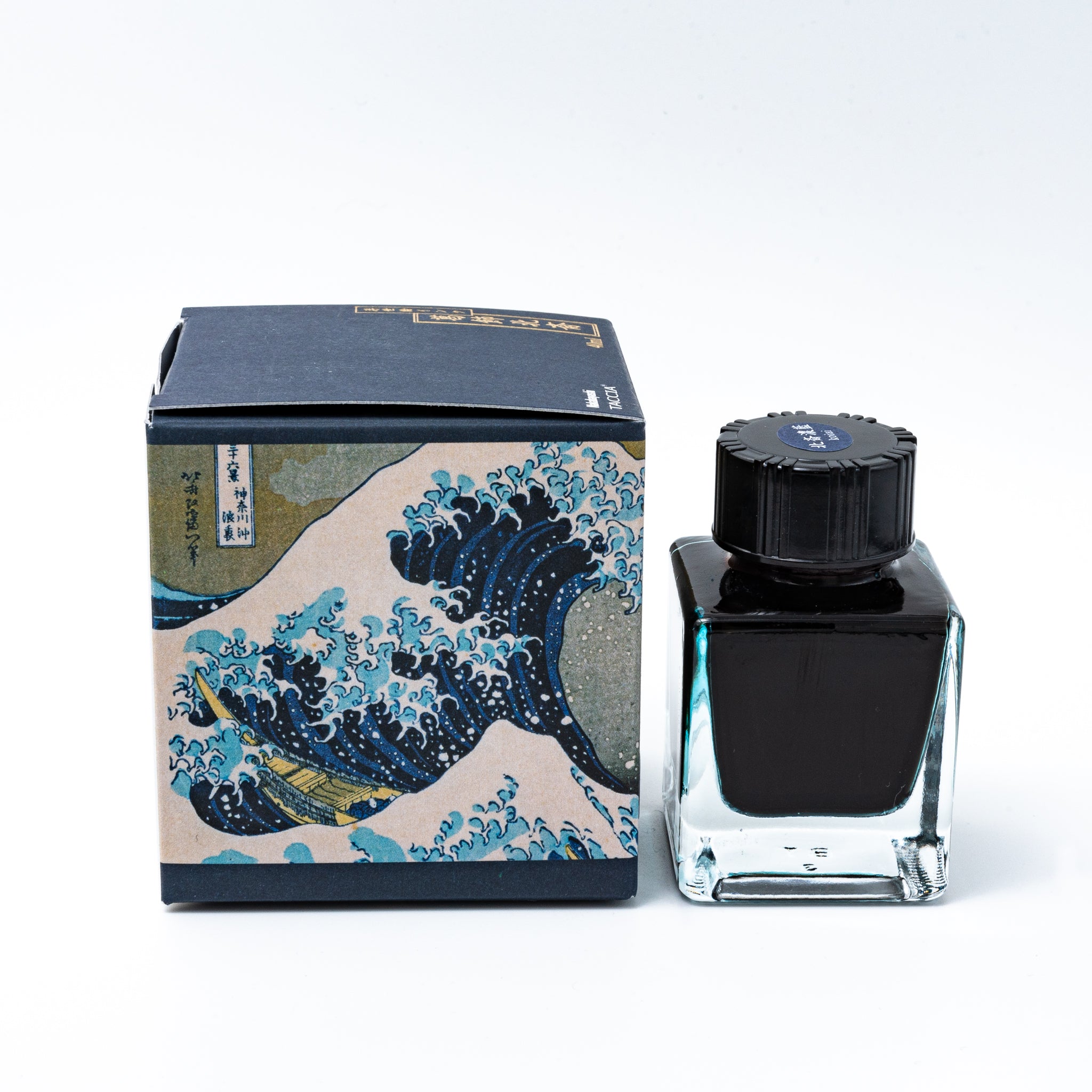 Japanese stationery fountain pen ink. The packaging features Ukiyo-e art of a great wave with Mount Fuji. The glass bottle contains 40ml of deep blue "Koiai" ink.  