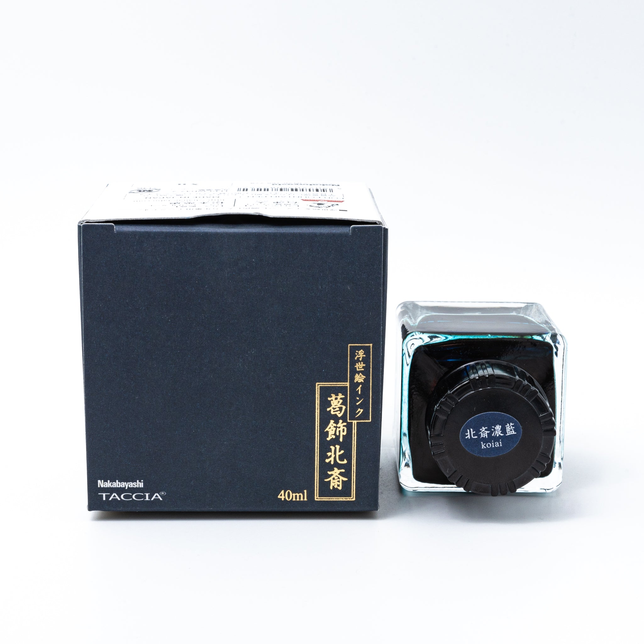 Japanese stationery fountain pen ink. The packaging features Ukiyo-e art of a great wave with Mount Fuji. The glass bottle contains 40ml of deep blue "Koiai" ink.  