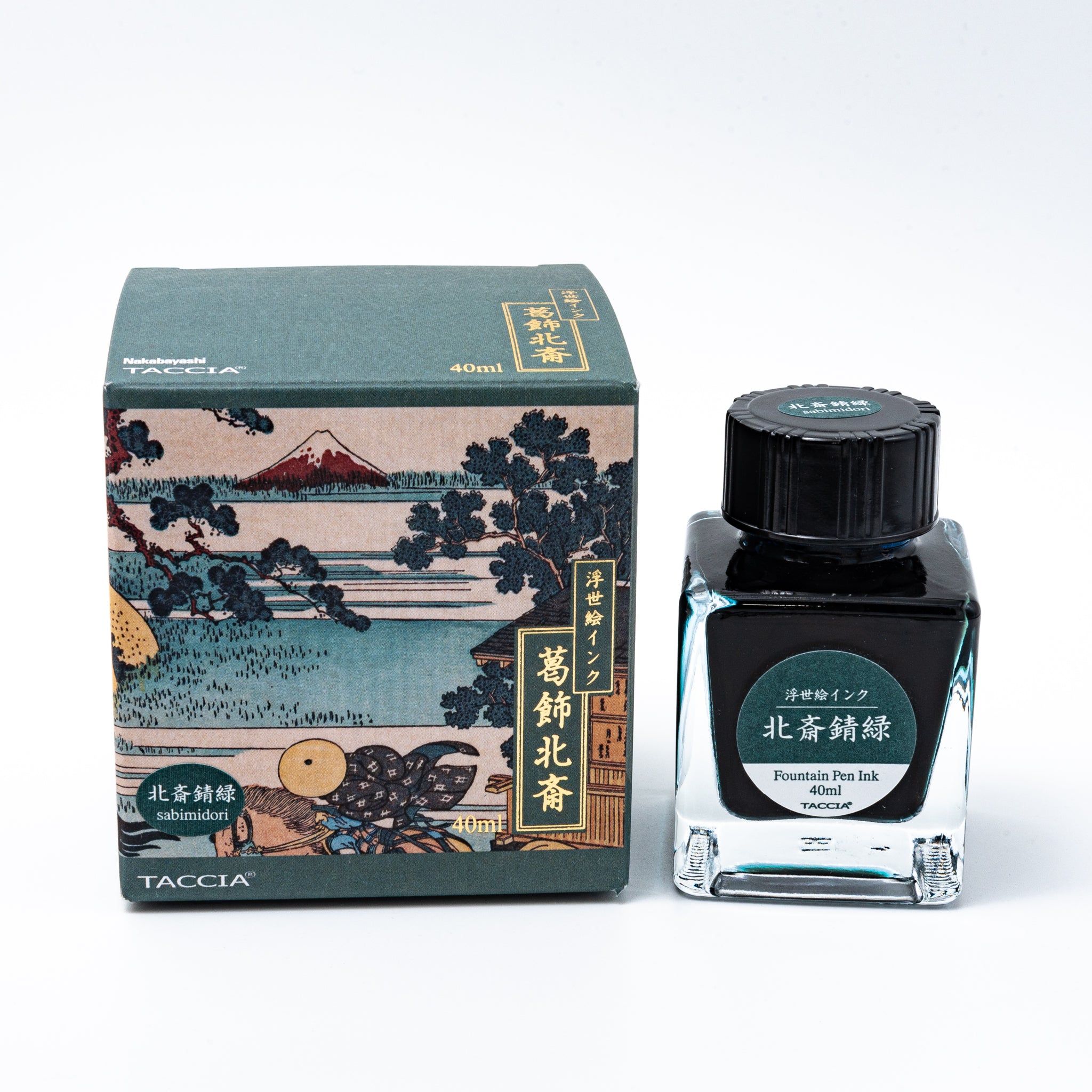 Japanese stationery fountain pen ink. The packaging features Ukiyo-e style art of a rural landscape with Mount Fuji. The glass bottle contains 40ml of teal "Sabimidori" ink.  