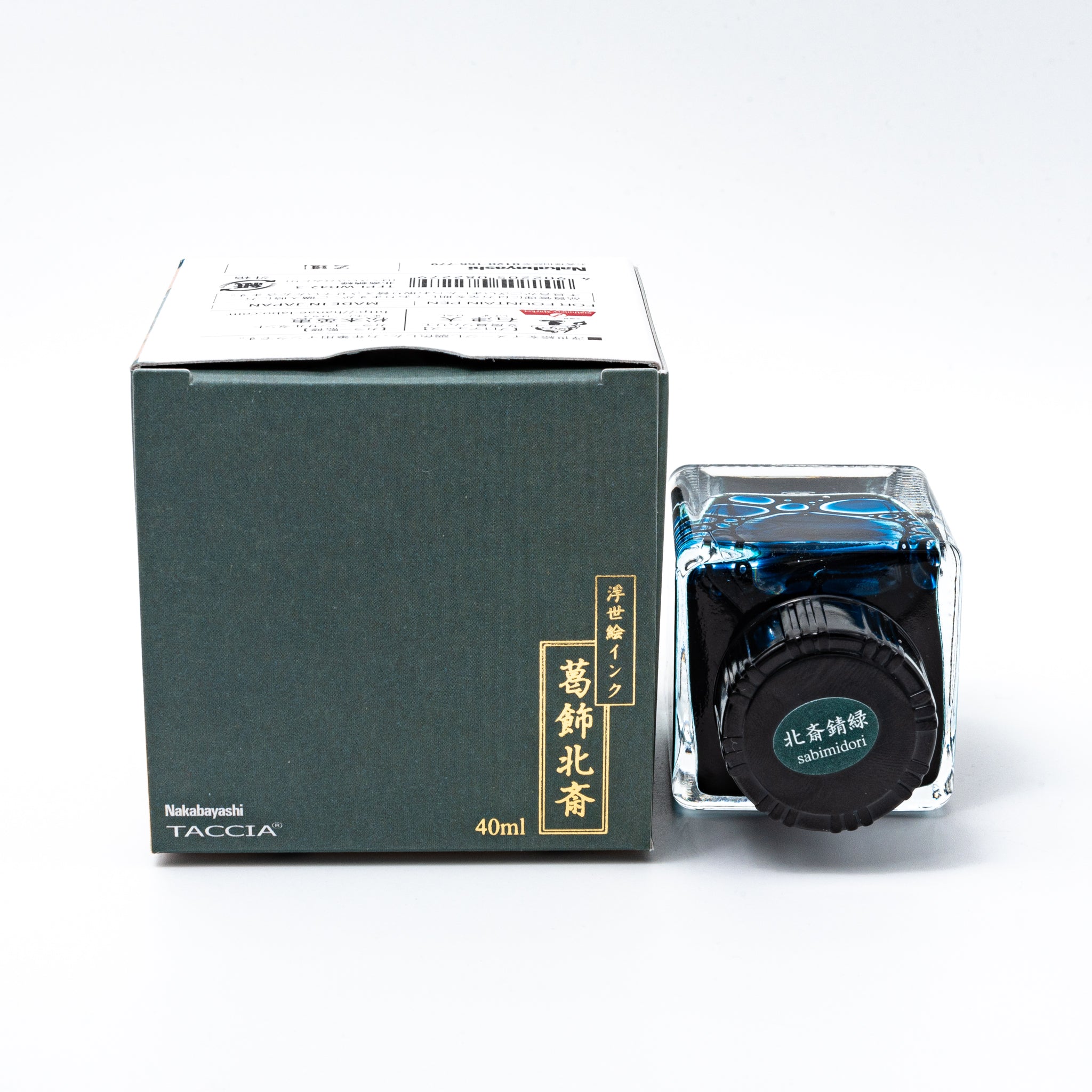 Japanese stationery fountain pen ink. The packaging features Ukiyo-e style art of a rural landscape with Mount Fuji. The glass bottle contains 40ml of teal "Sabimidori" ink.  