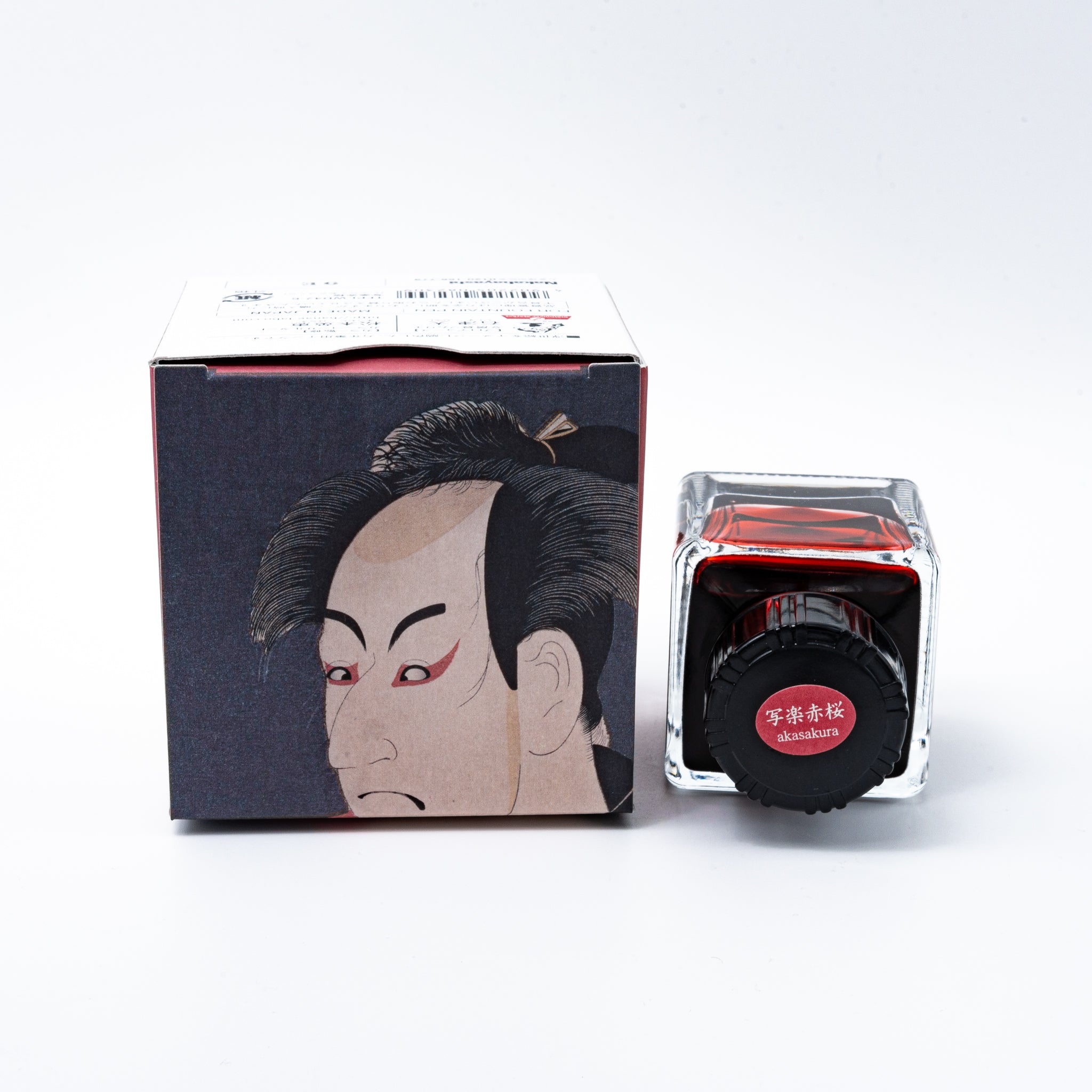 Japanese stationery fountain pen ink. The packaging features Ukiyo-e style art of a kabuki actor in a red kimono. The glass bottle contains 40ml of reddish-brown "Akasakura" ink.  