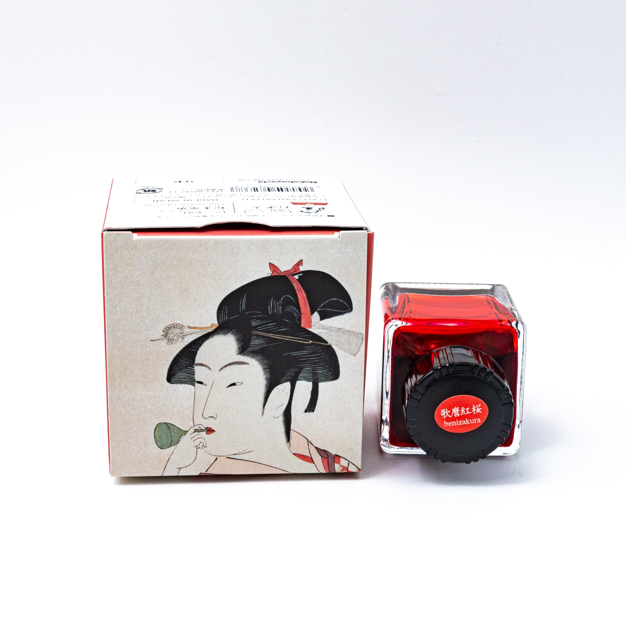 Japanese stationery fountain pen ink. The packaging features Ukiyo-e style art of a woman in a red checkered kimono. The glass bottle contains 40ml of red "Benizakura" ink.  