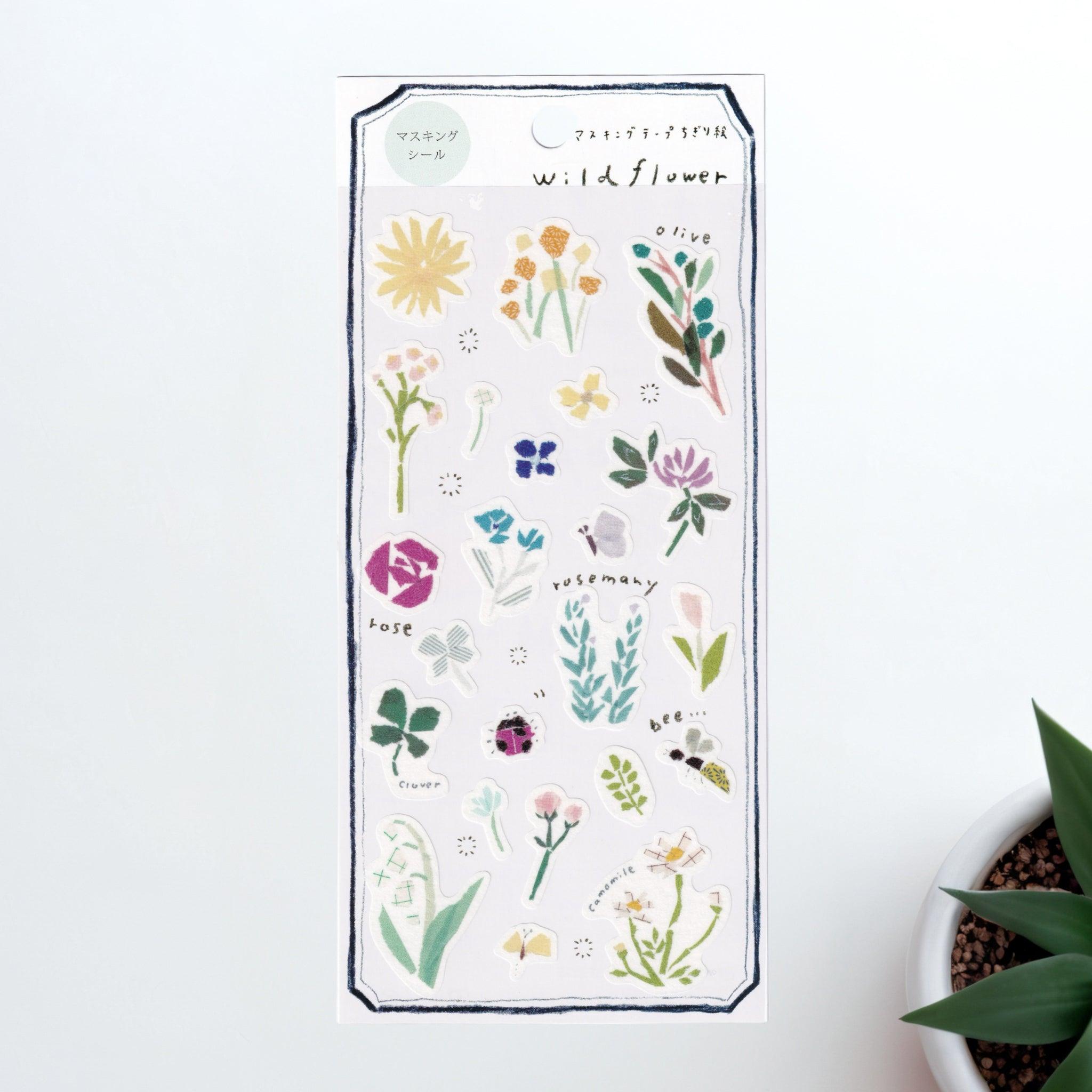 A Japanese stationery washi sticker sheet featuring wildflower-themed designs, including roses, rosemary, clover, bees, and delicate blossoms, in a soft watercolor style.