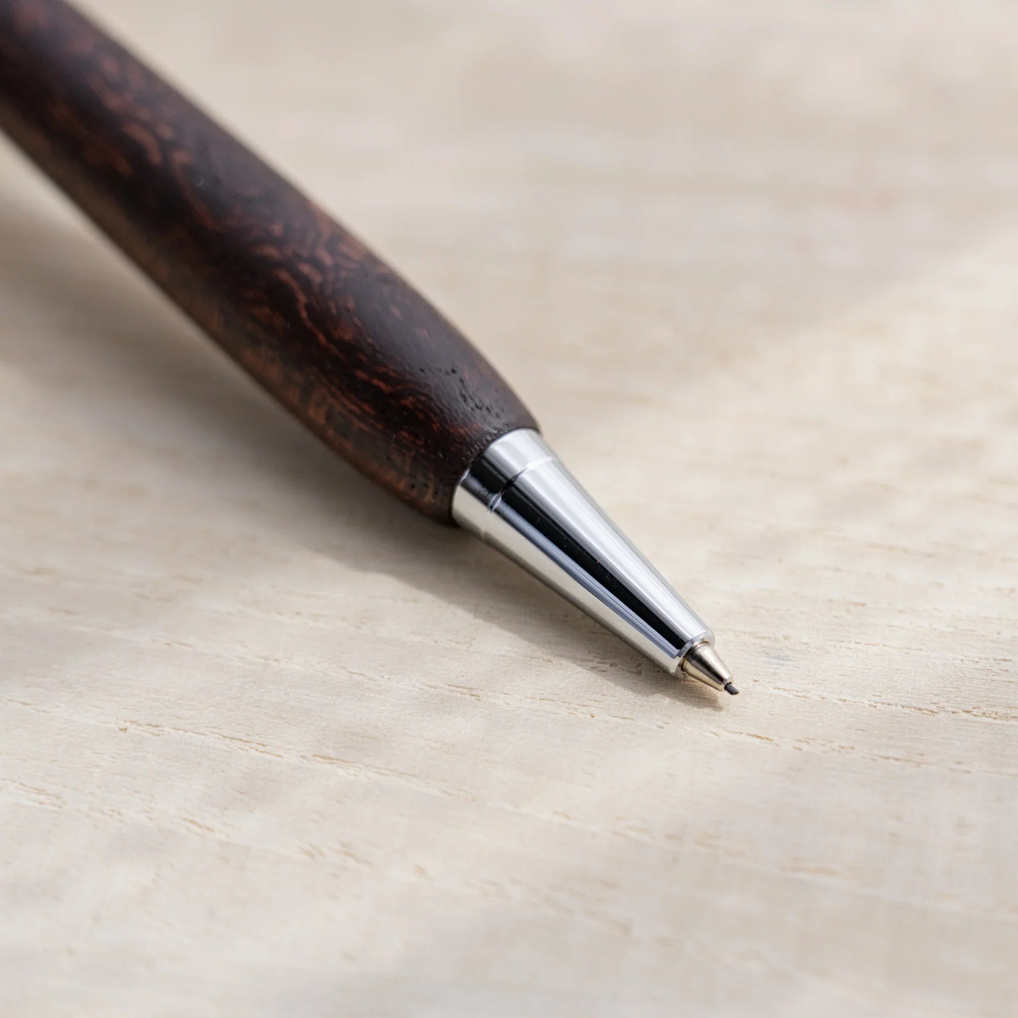 Zelkova wood urushi lacquered mechanical pencil in dark reddish-brown on white, Japanese keyaki, silver knock