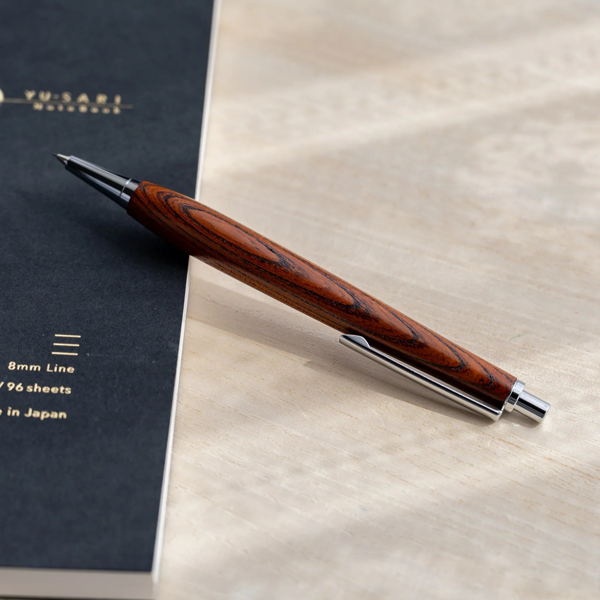 Zelkova wood urushi lacquered mechanical pencil in amber-brown, Japanese keyaki wood, angled full-body view