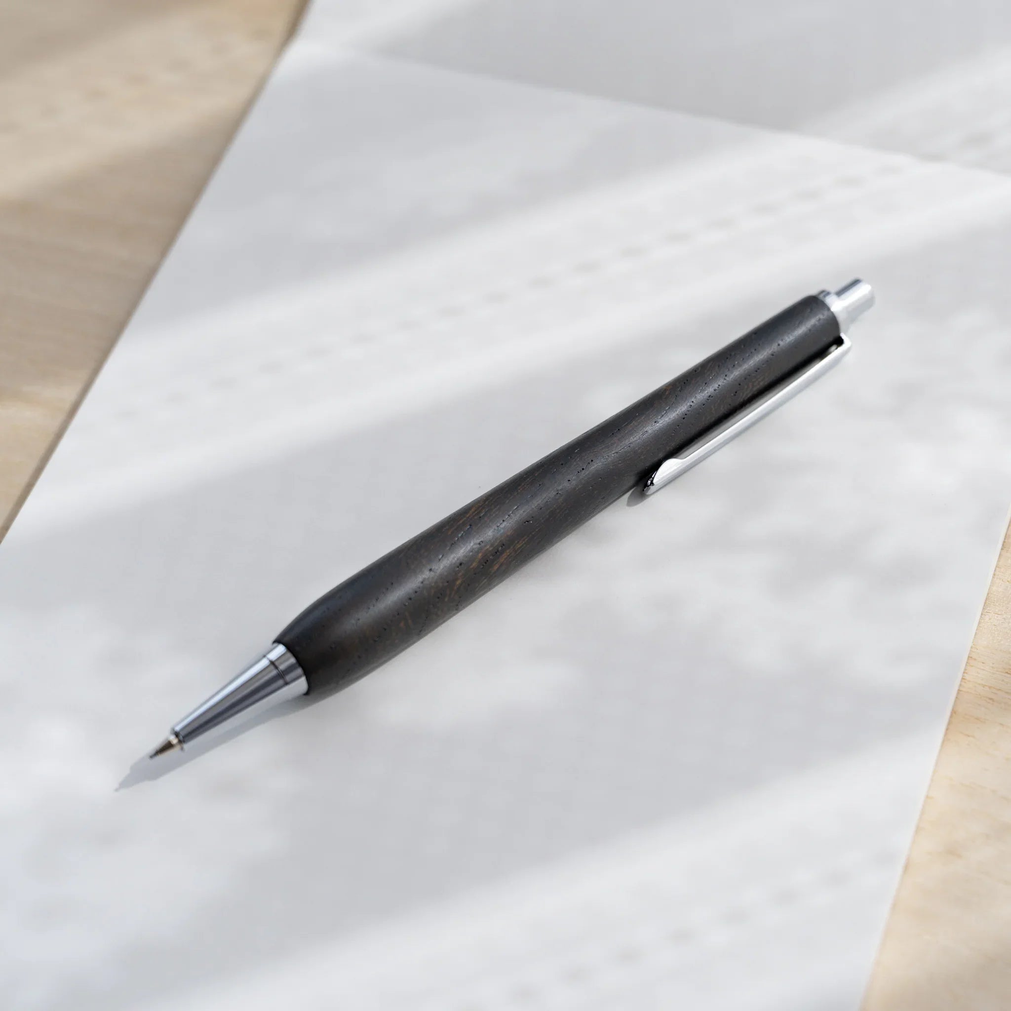 Charcoal black zelkova wood urushi mechanical pencil, close-up of silver cone tip and lead, Japanese keyaki wood