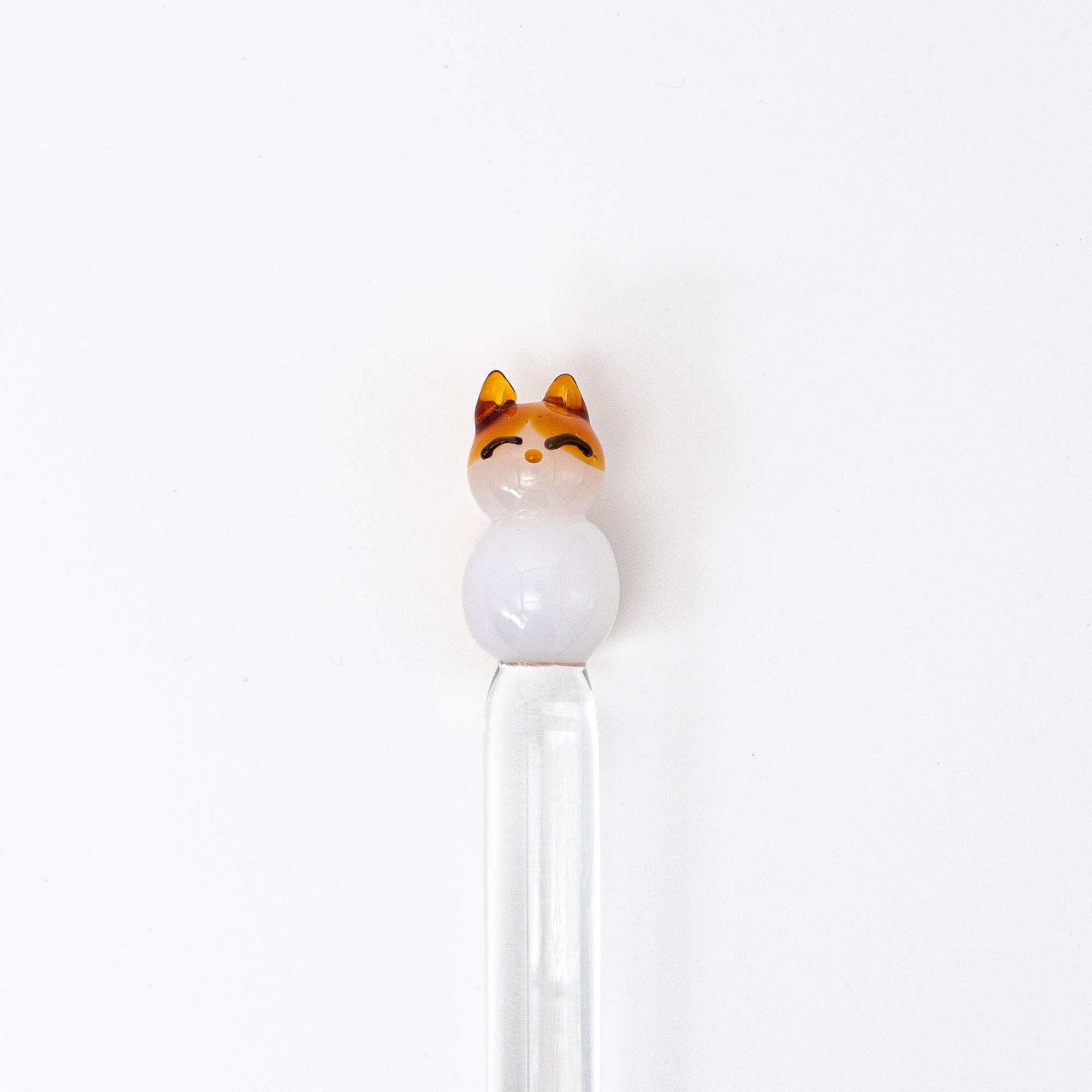 Glass pen with a cat topper and clear shaft, featuring a cute and playful design. Perfect for adding charm to your writing.