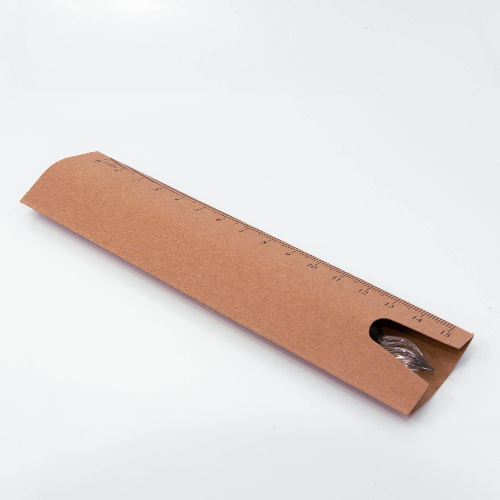 Eco-friendly ruler-style brown packaging with Clarto logo, designed to protect and store the glass pen securely.