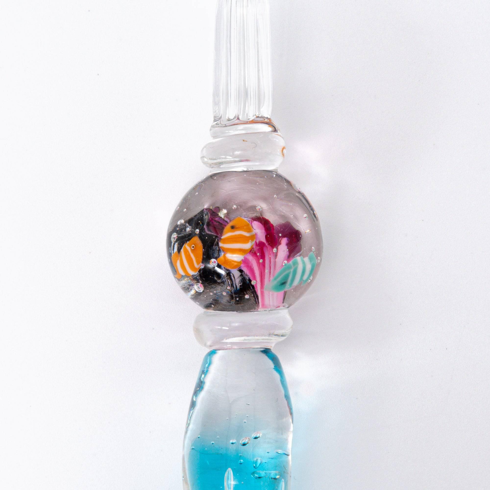 Glass pen with clownfish motif encased in a sphere, resembling a miniature aquarium. Perfect for fans of Japanese stationery.