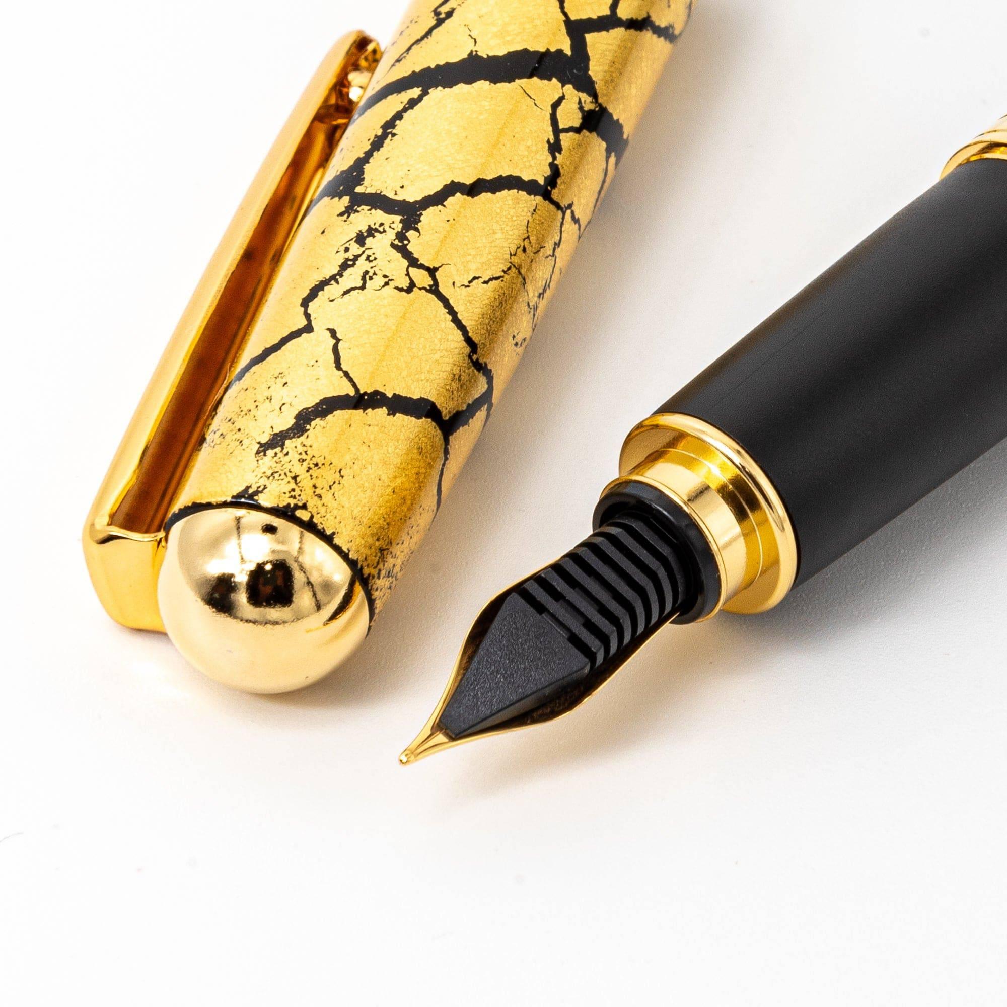 Close-up of the pen cap and clip, showcasing the crackled gold-leaf texture and smooth metallic clip design.