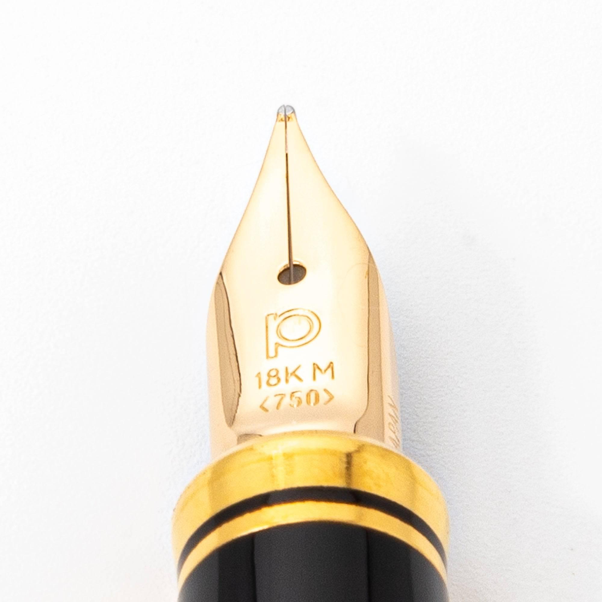 Extreme close-up of the 18K gold nib on a Mt. Fuji maki-e Japanese fountain pen, showcasing precision engravings and premium finish.