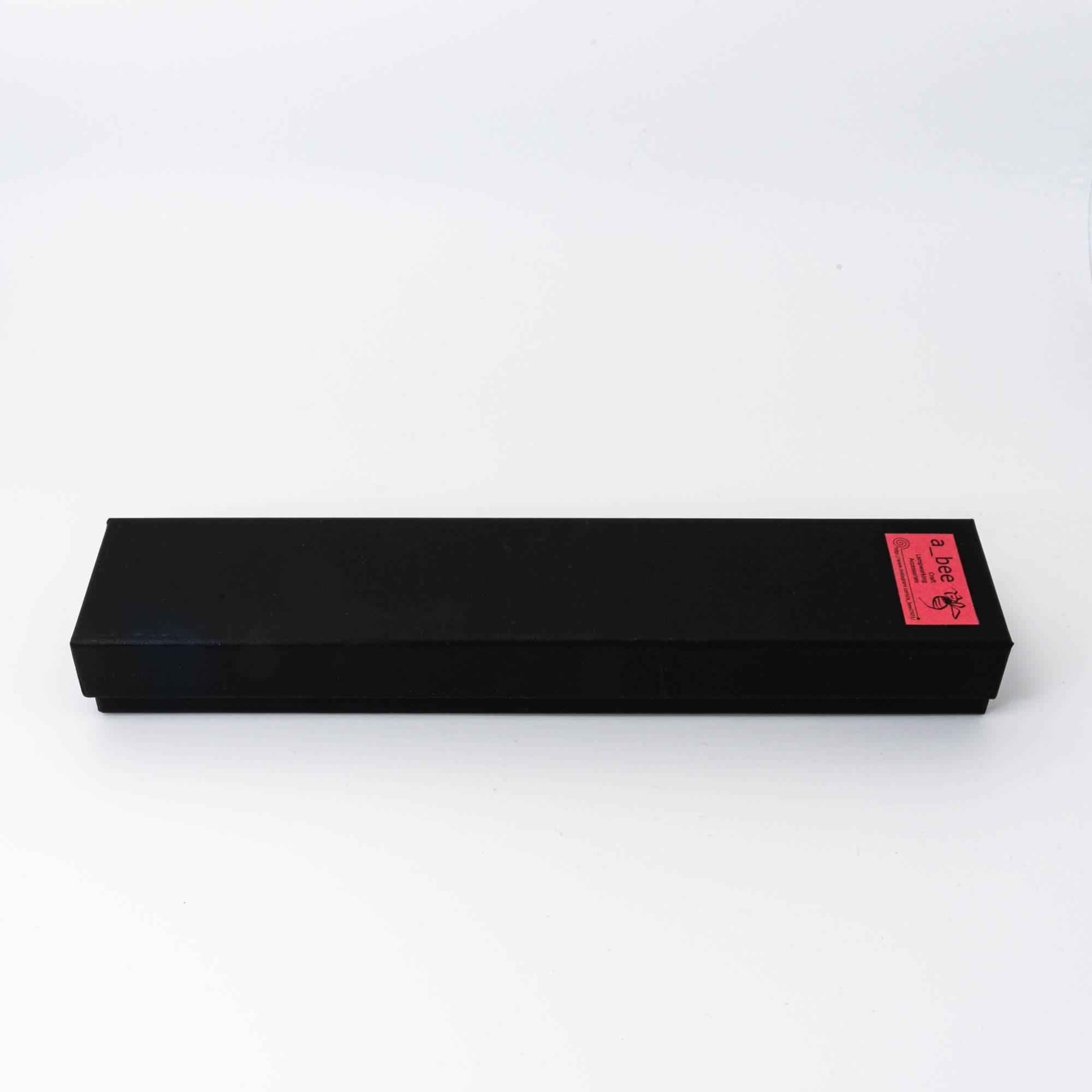 Black packaging box for glass pen with red label, designed to protect Japanese glass pens, perfect for stationery collectors.