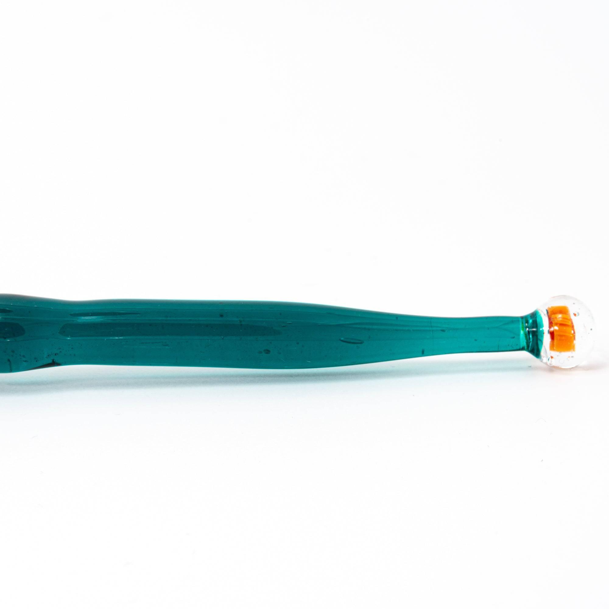 Side view of glass pen with goldfish motif encased like a fishbowl, featuring dark green handle.