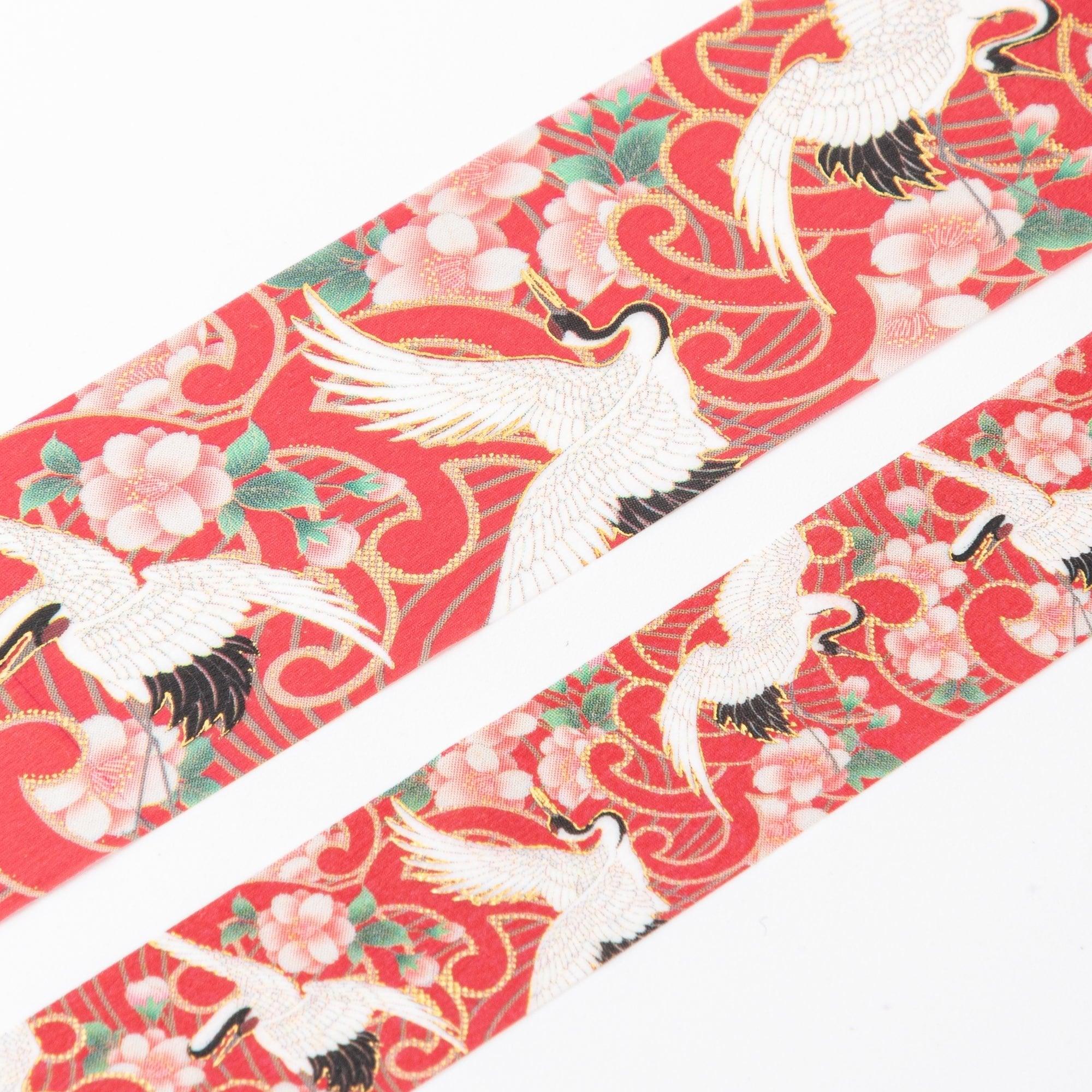 Close-up of Iyo Washi Tape from the Kimono Beauty Series, showcasing detailed crane patterns with vibrant colors and elegant texture.  