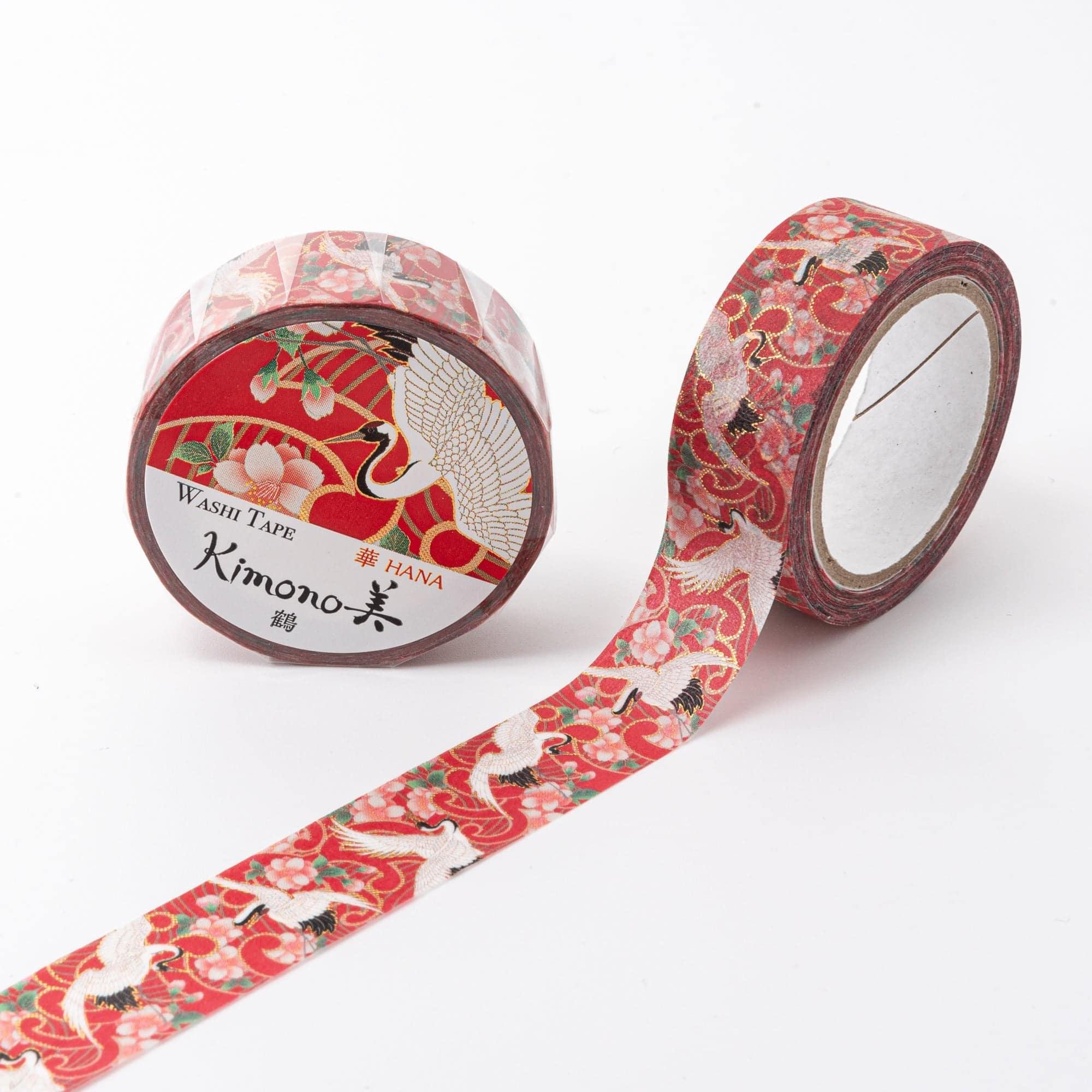 Roll of Iyo Washi Tape with crane designs, unraveling to reveal its rich traditional art, placed on a wooden desk for decoration.  