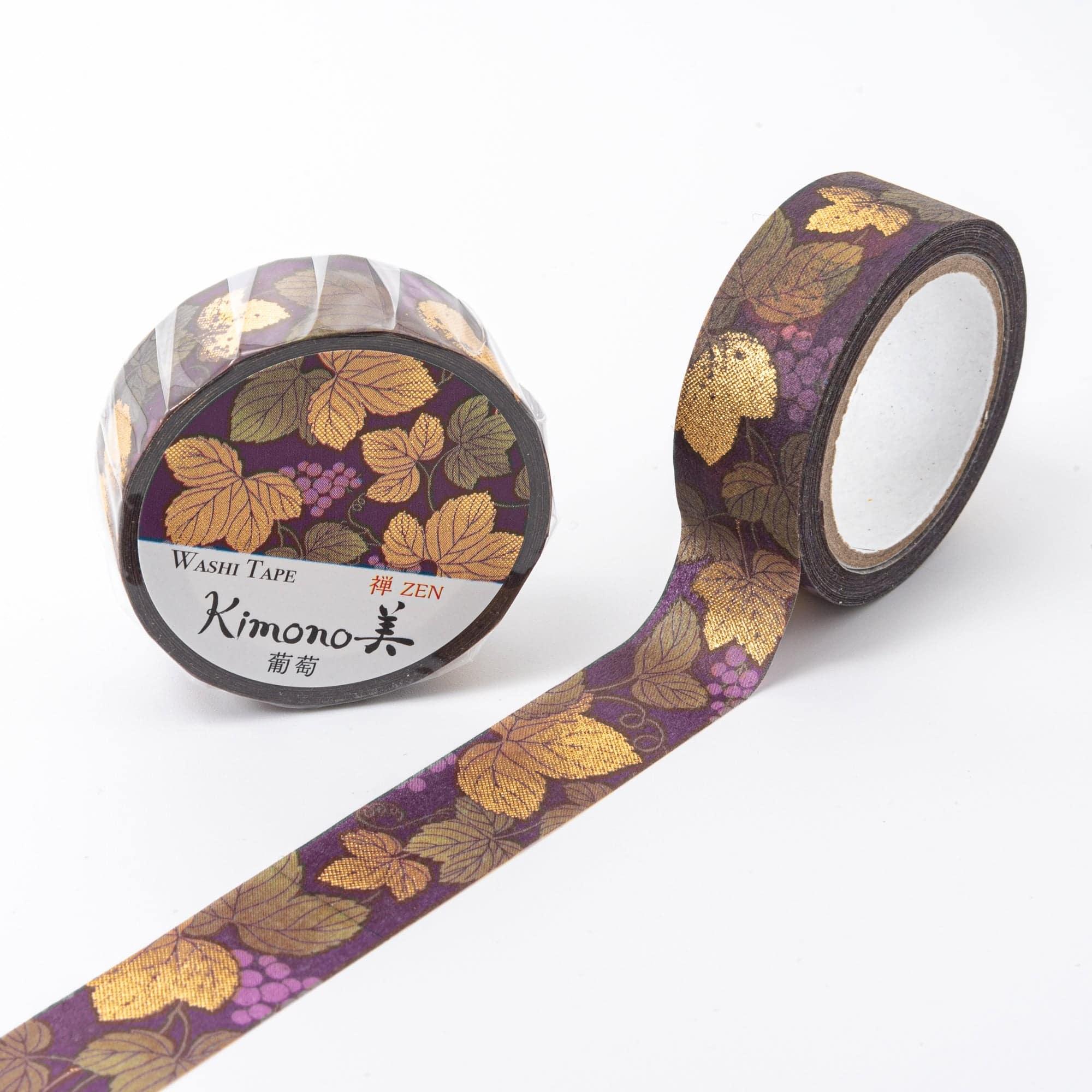 Roll of Iyo Washi Tape with grape patterns, unraveling to reveal its detailed motifs, placed on a wooden surface under soft lighting.  