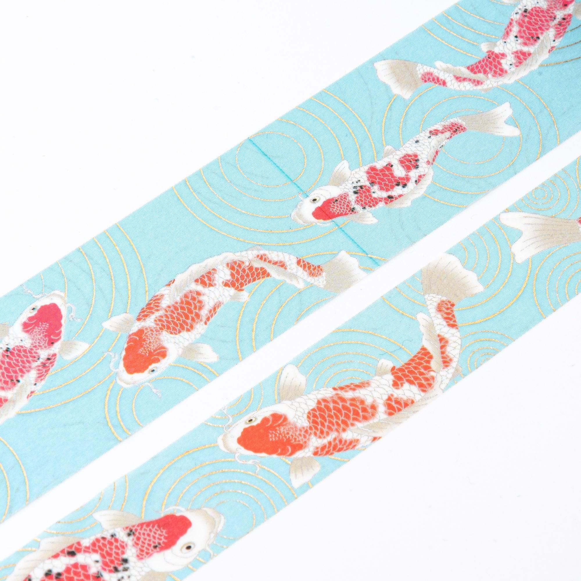 Close-up of Iyo Washi Tape showcasing vibrant koi patterns, emphasizing intricate details and vivid colors on a wooden desk.  