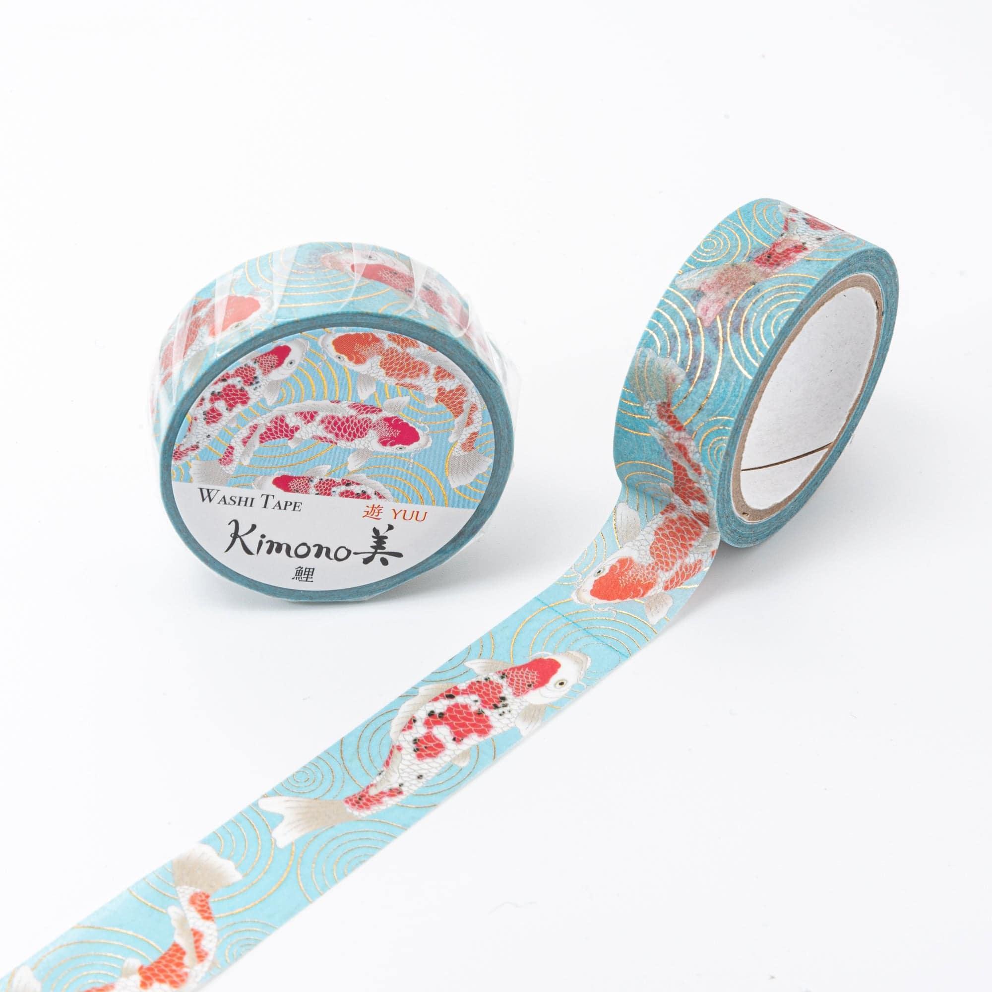 Roll of Iyo Washi Tape with koi designs, unraveling to reveal its artistic motifs, placed on a wooden surface under soft lighting.  