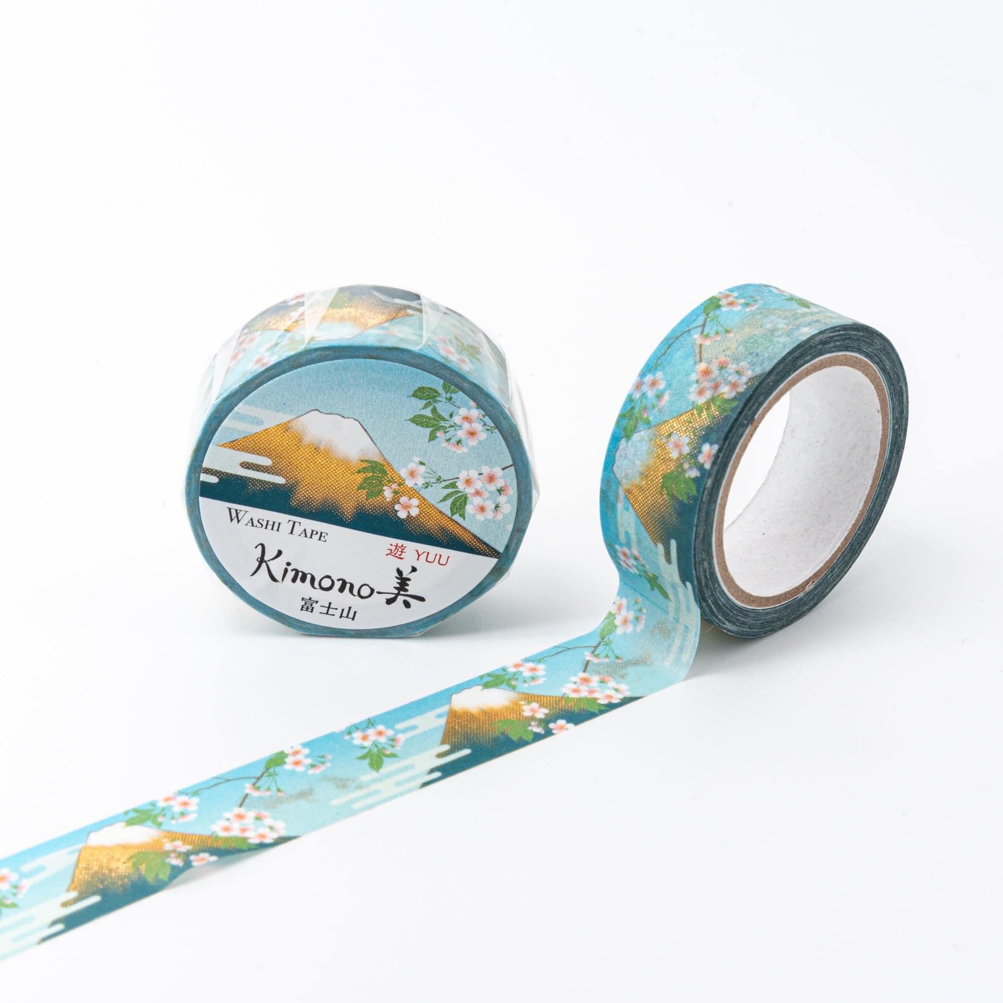 Roll of Iyo Washi Tape with Mt. Fuji patterns, unraveling to reveal its artistic motifs, placed on a wooden desk under soft lighting.  