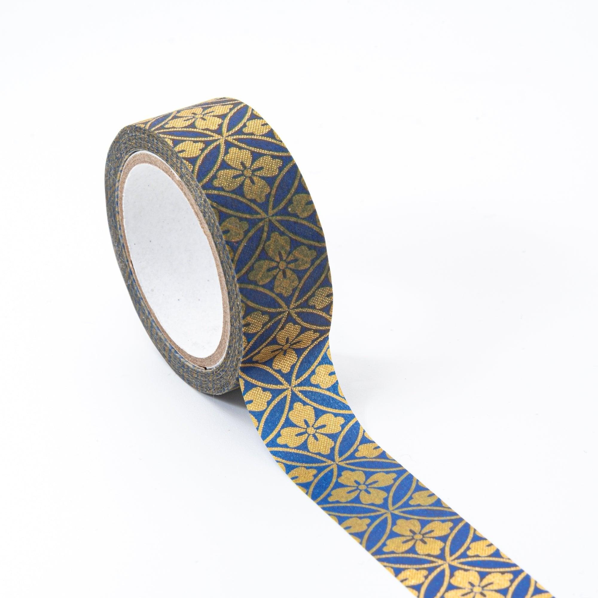 Roll of Iyo Washi Tape with Shippo designs, unraveling to reveal its artistic motifs, placed on a wooden surface under soft lighting.  